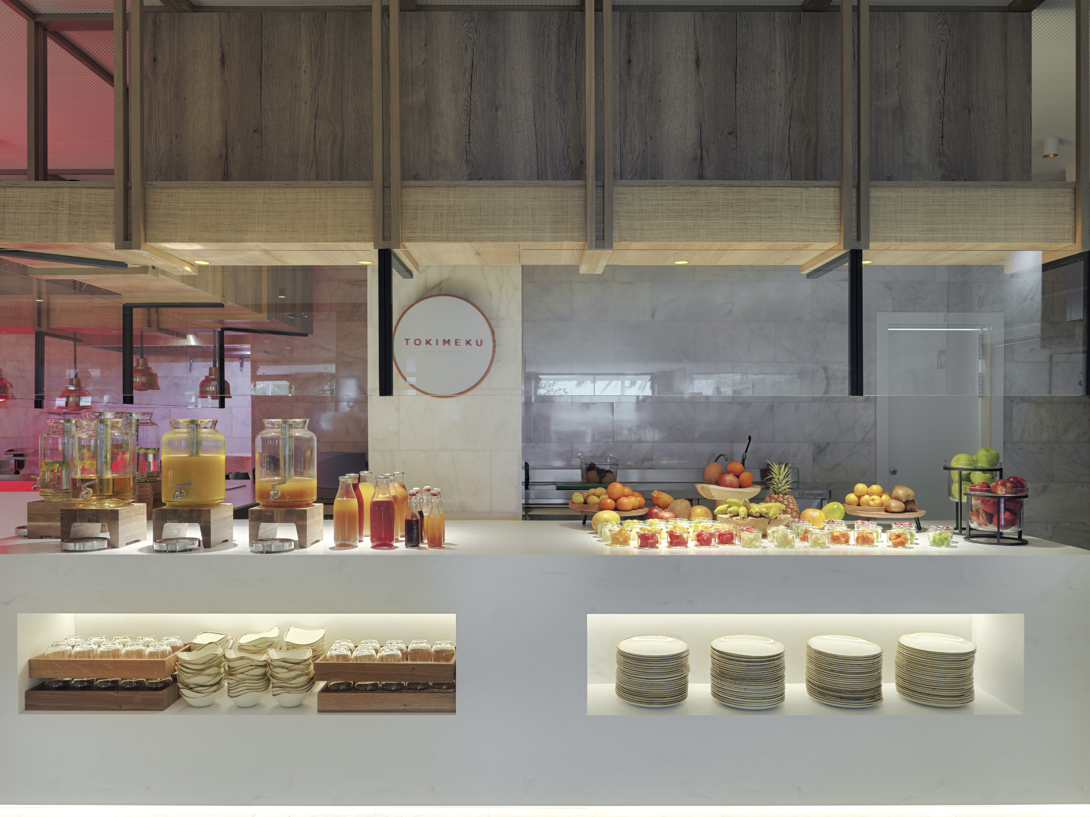 Tokimeku breakfast buffet with fresh juices, various fruits, and plates.