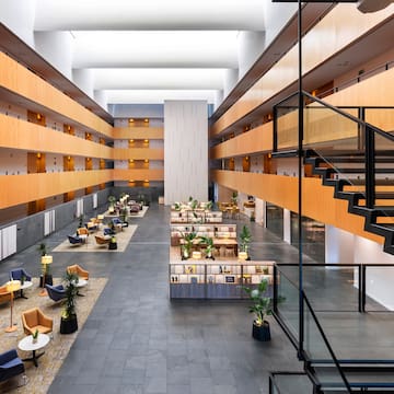 a large building with a staircase and tables