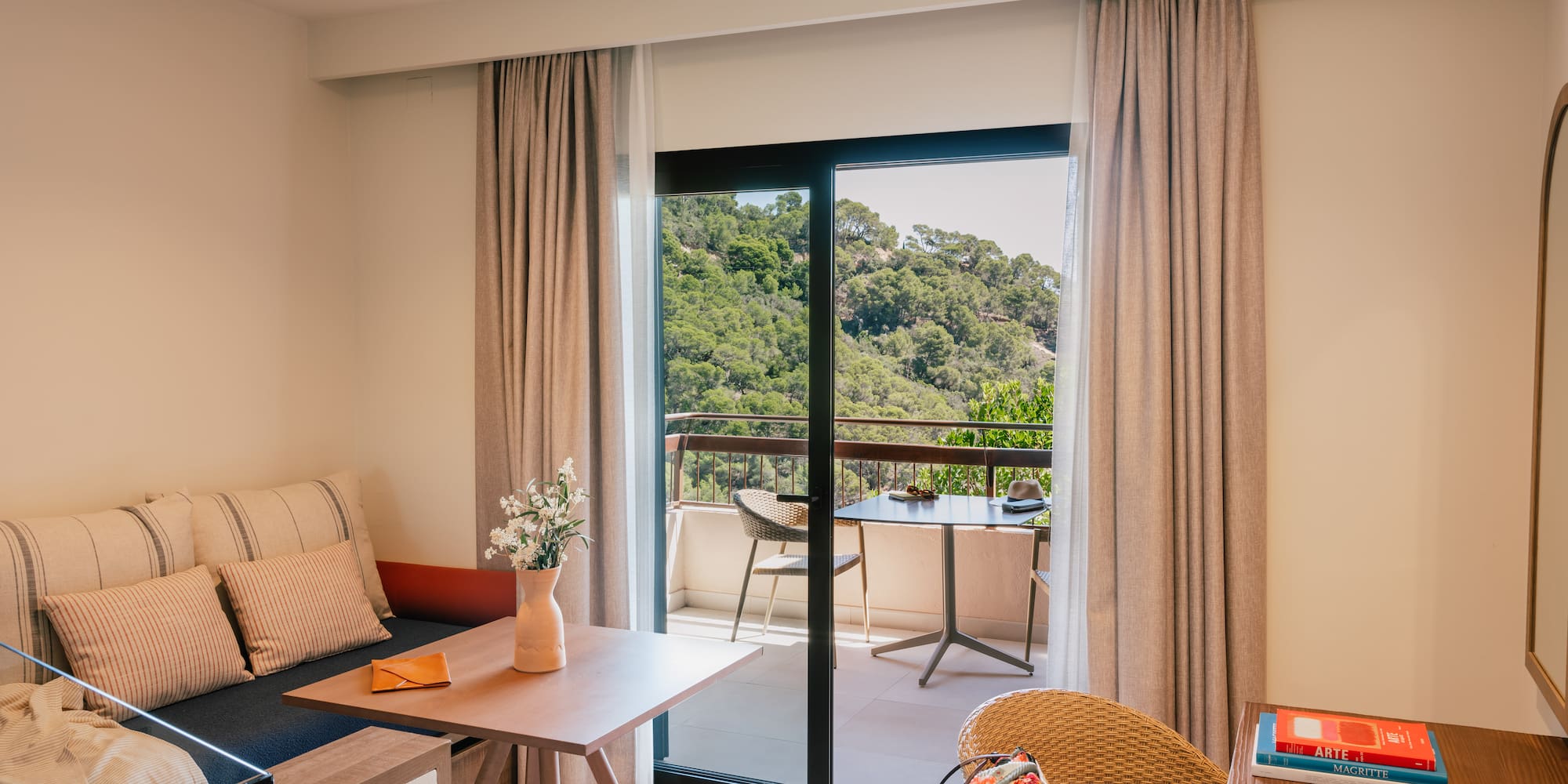 a room with a couch and a table and chairs