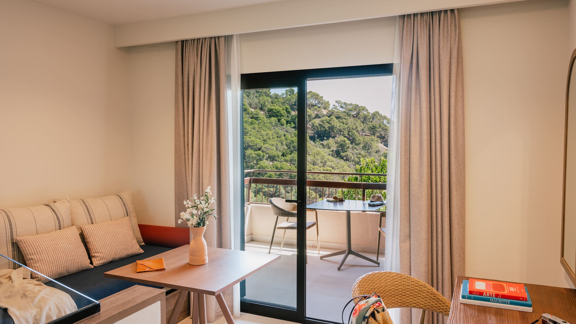 a room with a couch and a table and chairs