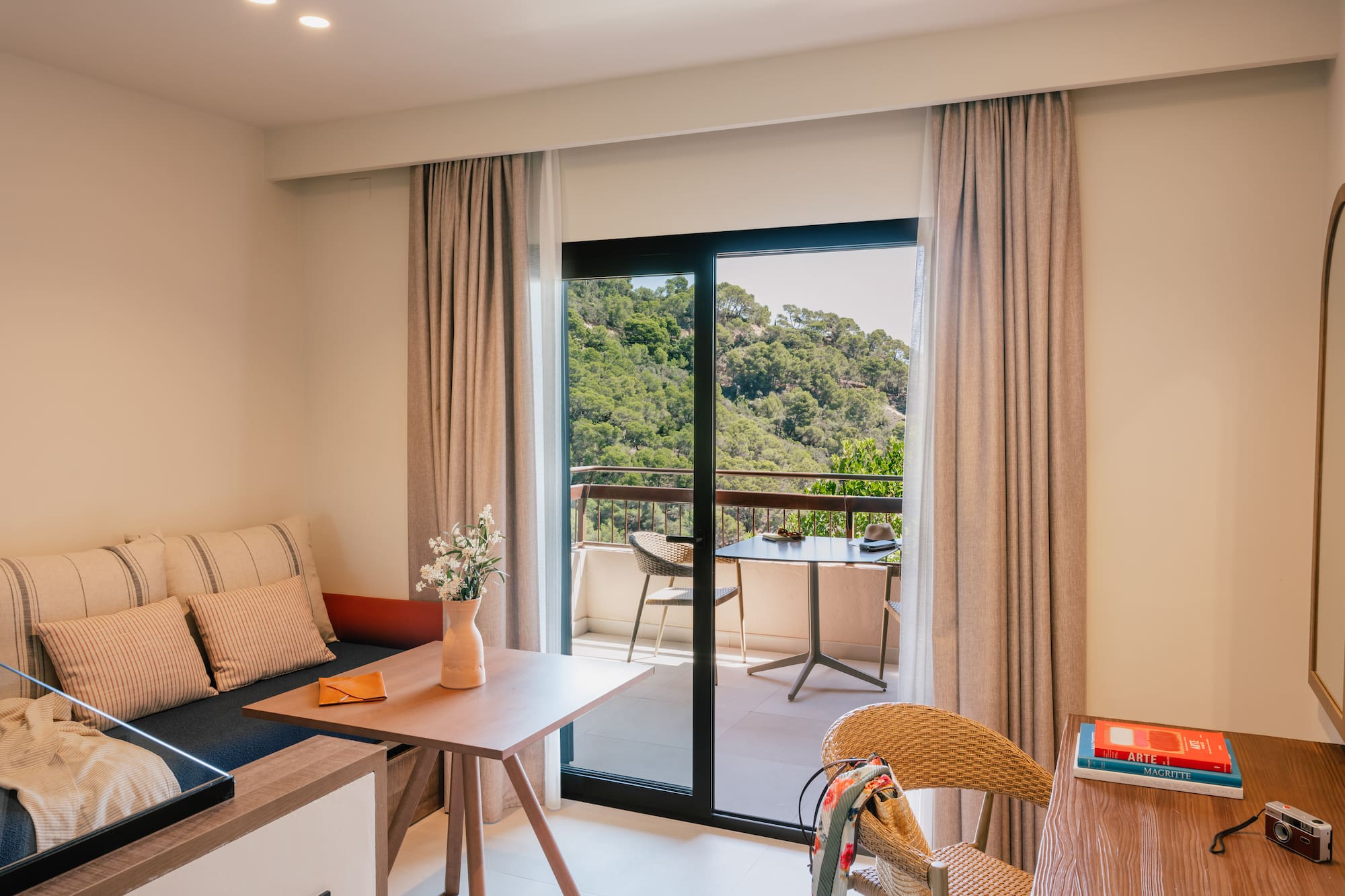 a room with a couch and a table and chairs