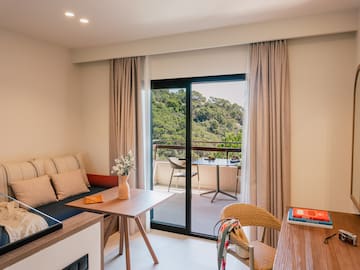 a room with a couch and a table and chairs