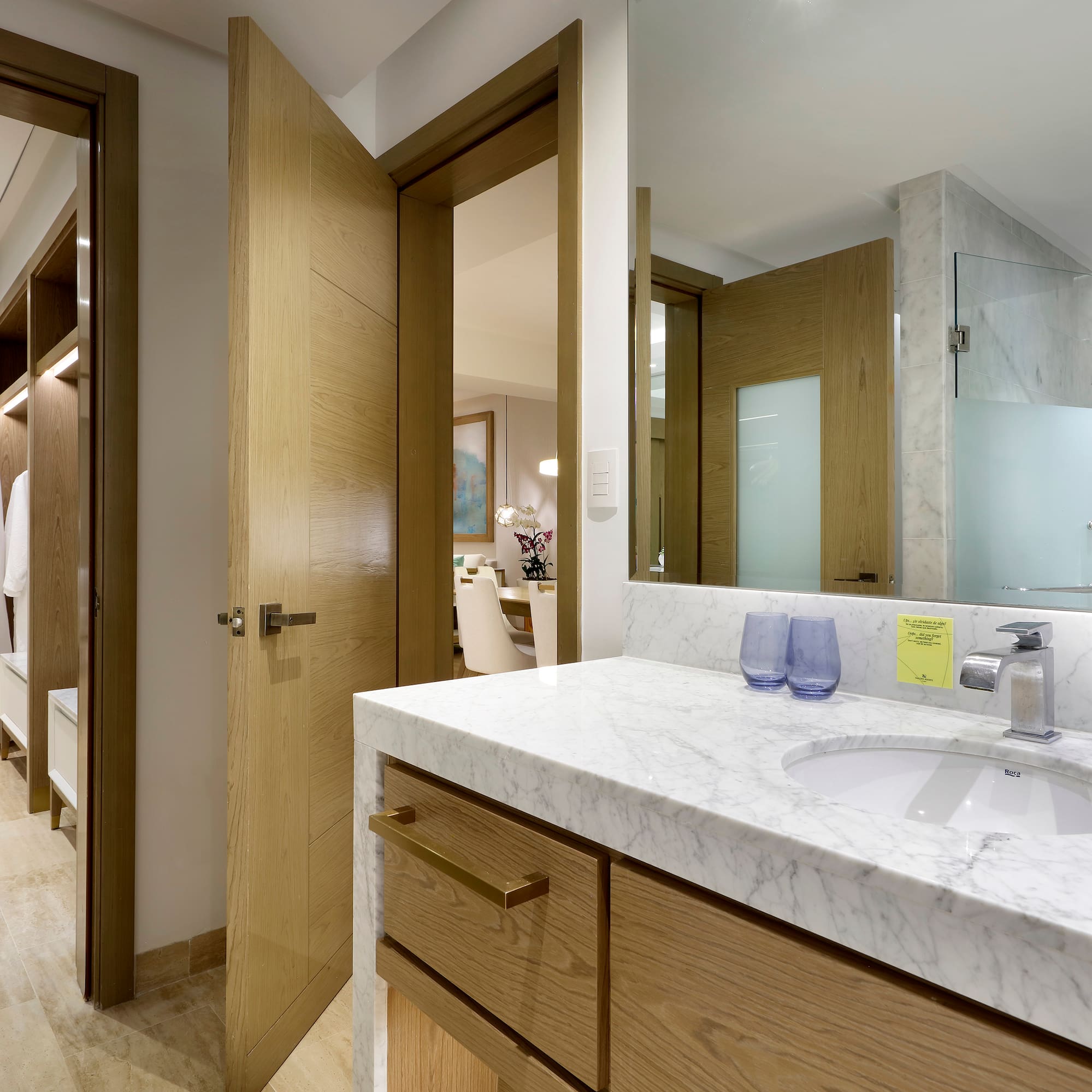 a bathroom with a marble countertop and a wood door