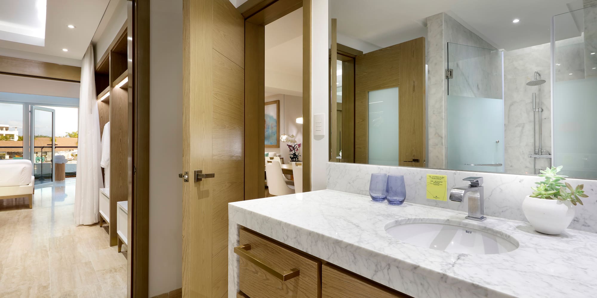 a bathroom with a marble countertop and a wood door