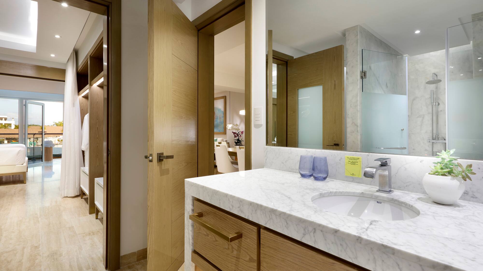 a bathroom with a marble countertop and a wood door