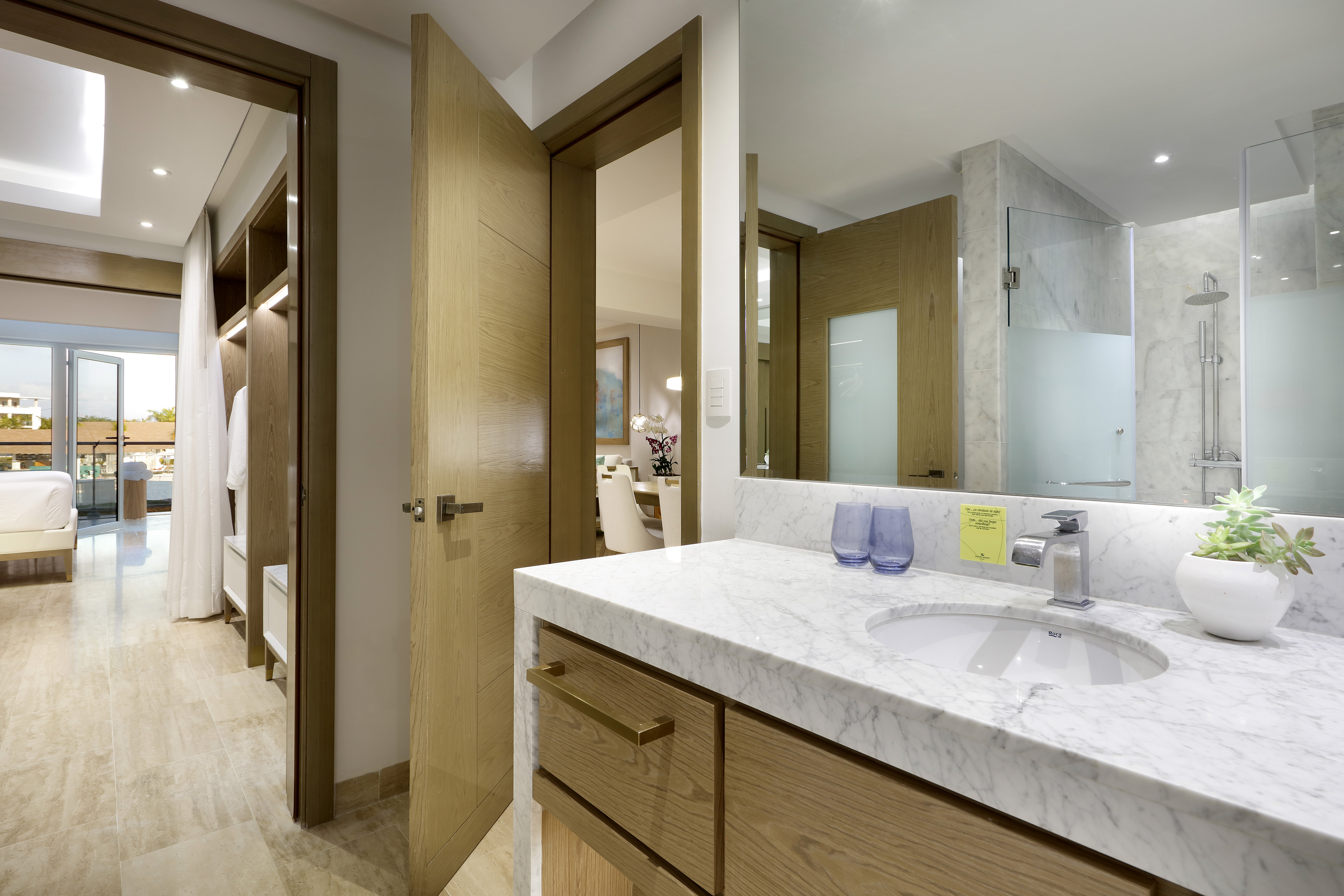 a bathroom with a marble countertop and a wood door
