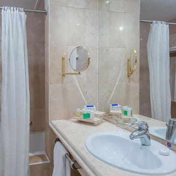 a bathroom with a sink and shower curtain