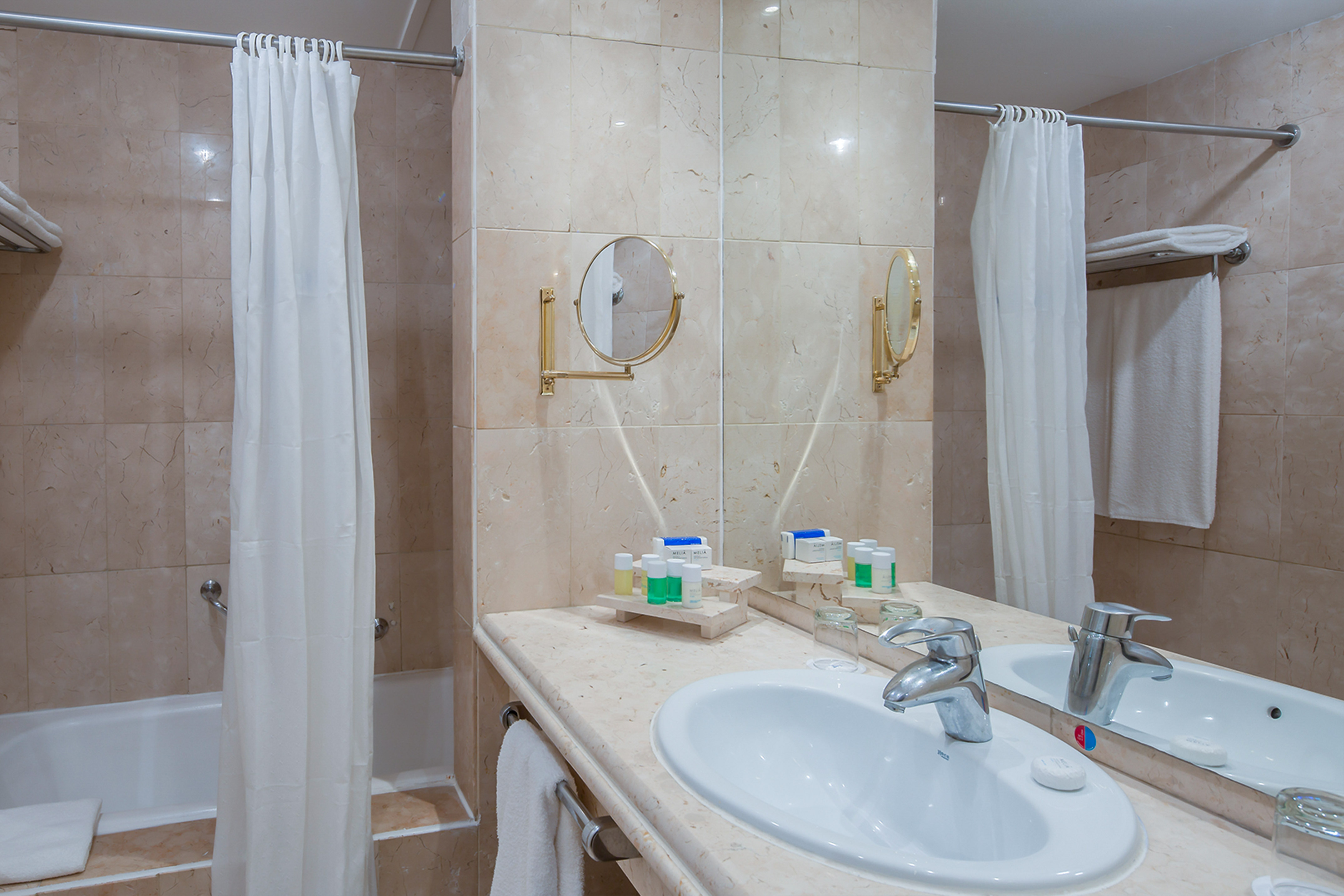 a bathroom with a sink and shower curtain