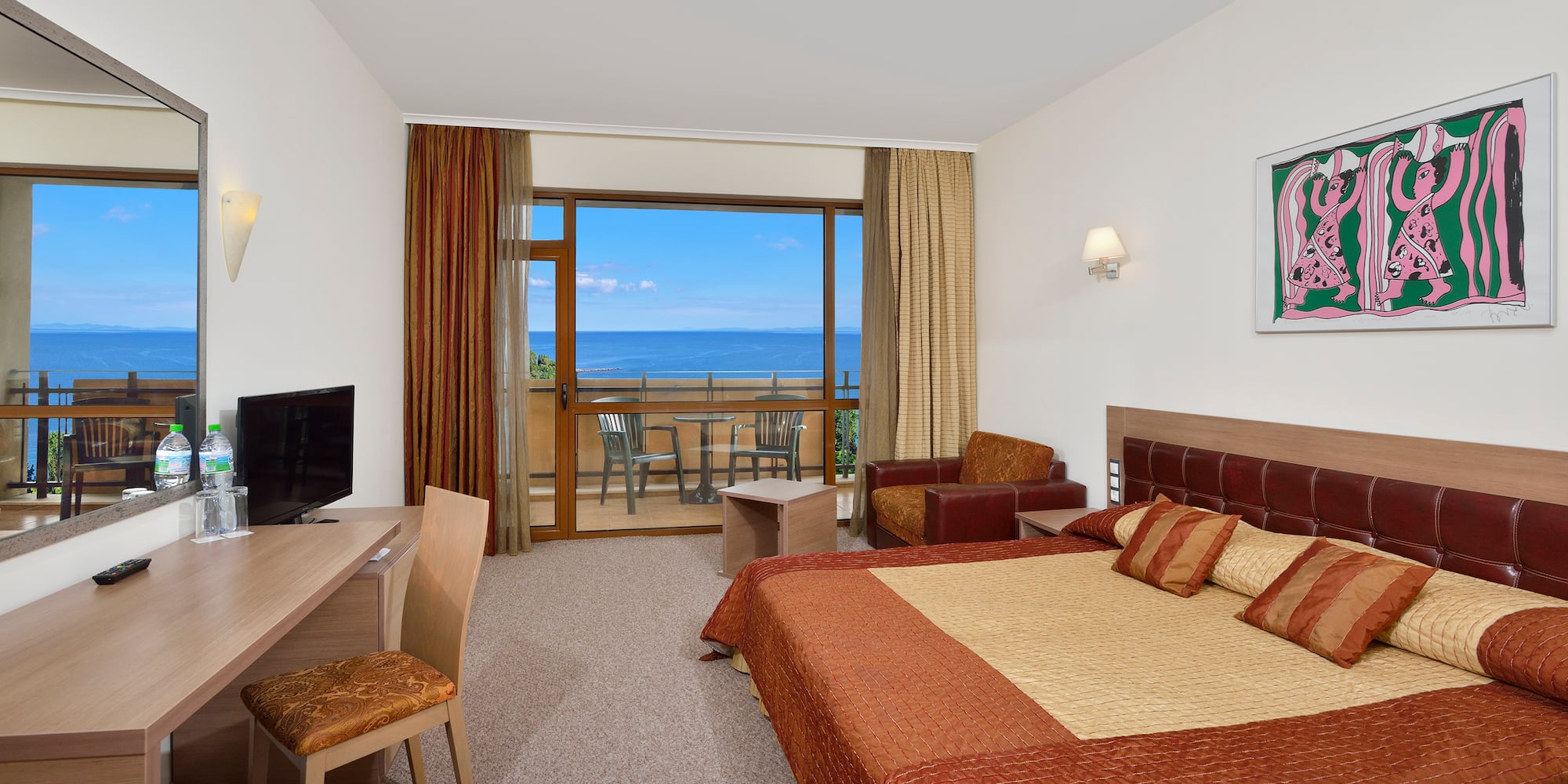 a room with a bed and a television