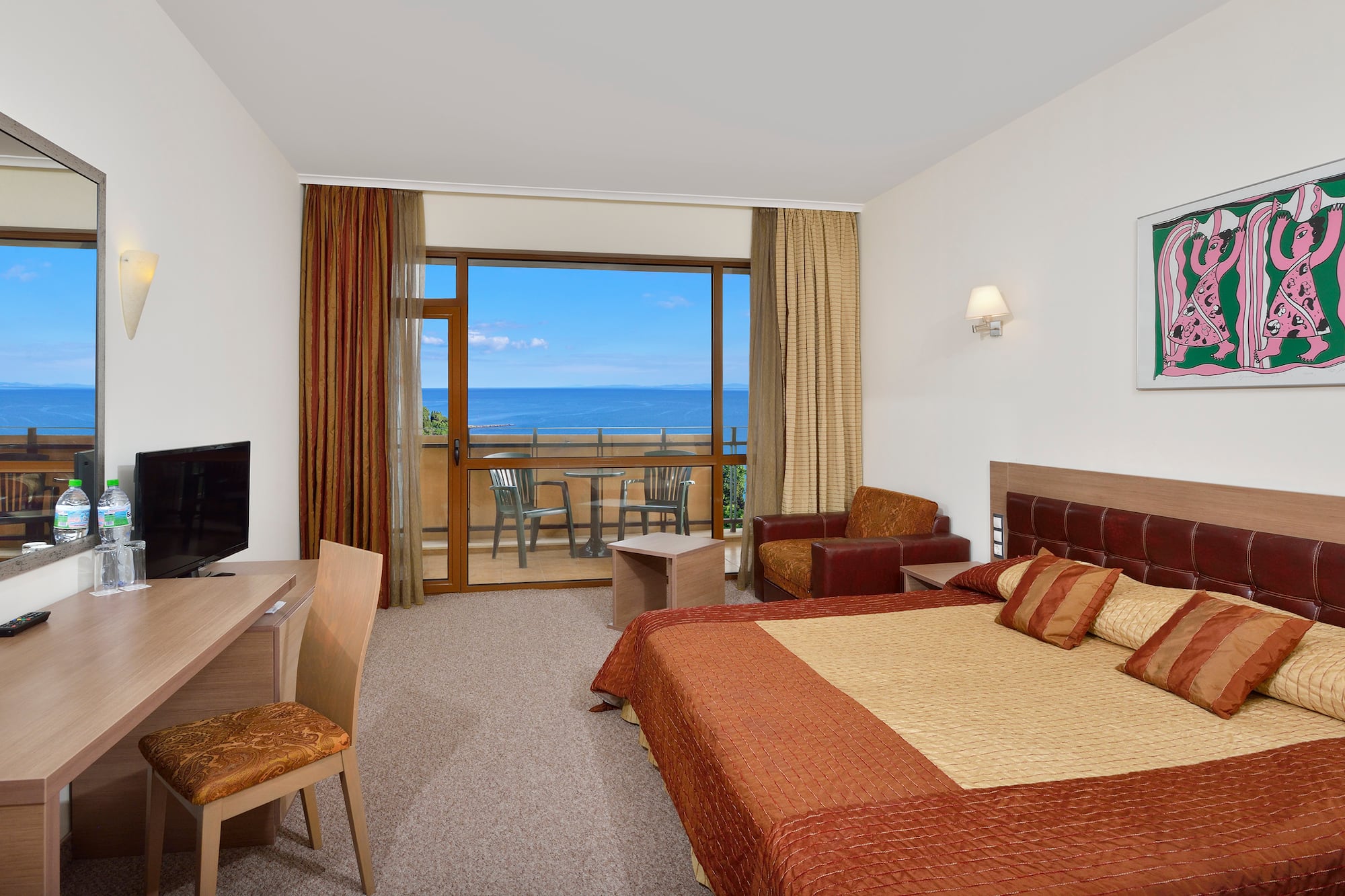 a room with a bed and a television