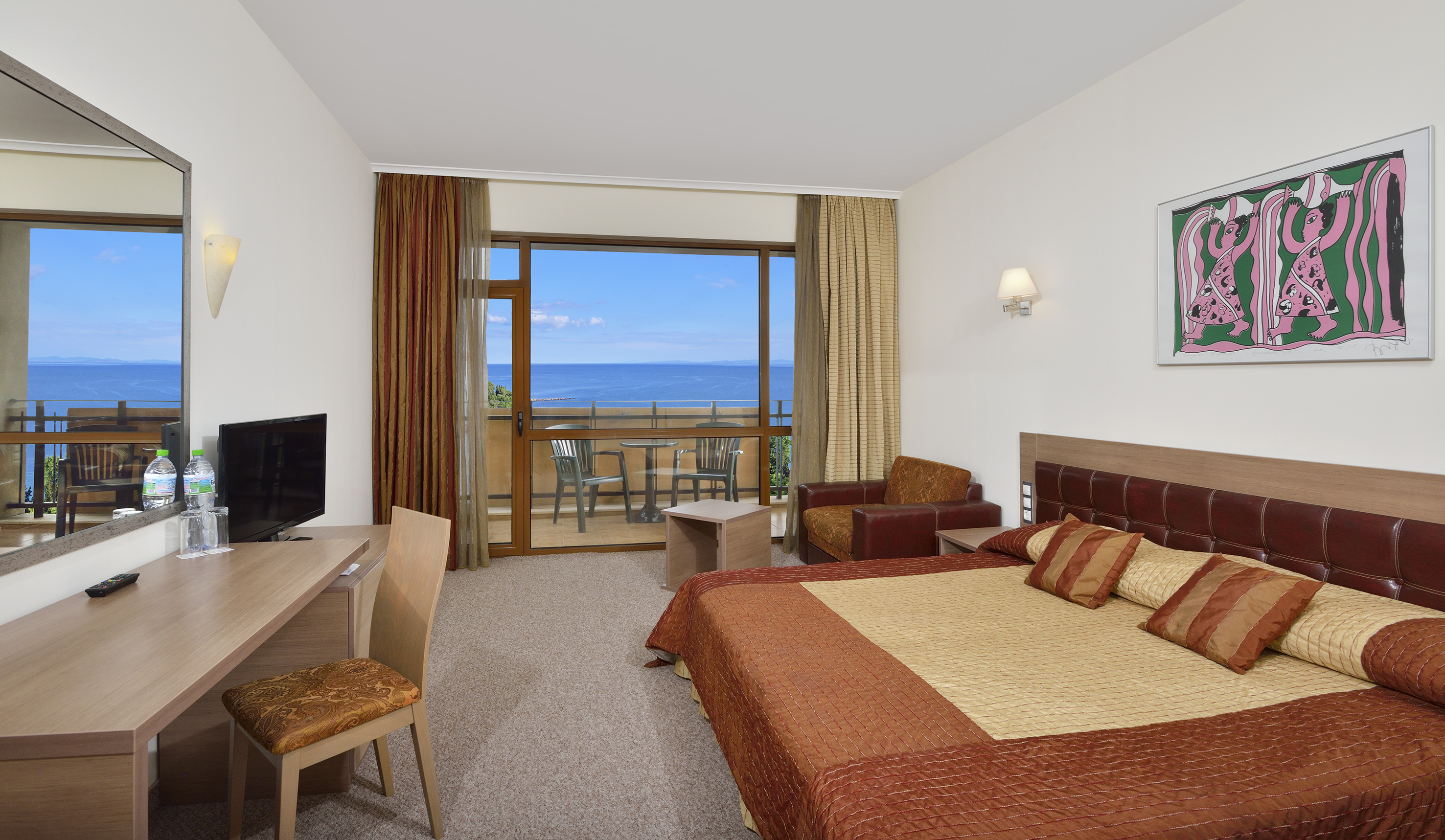 a room with a bed and a television
