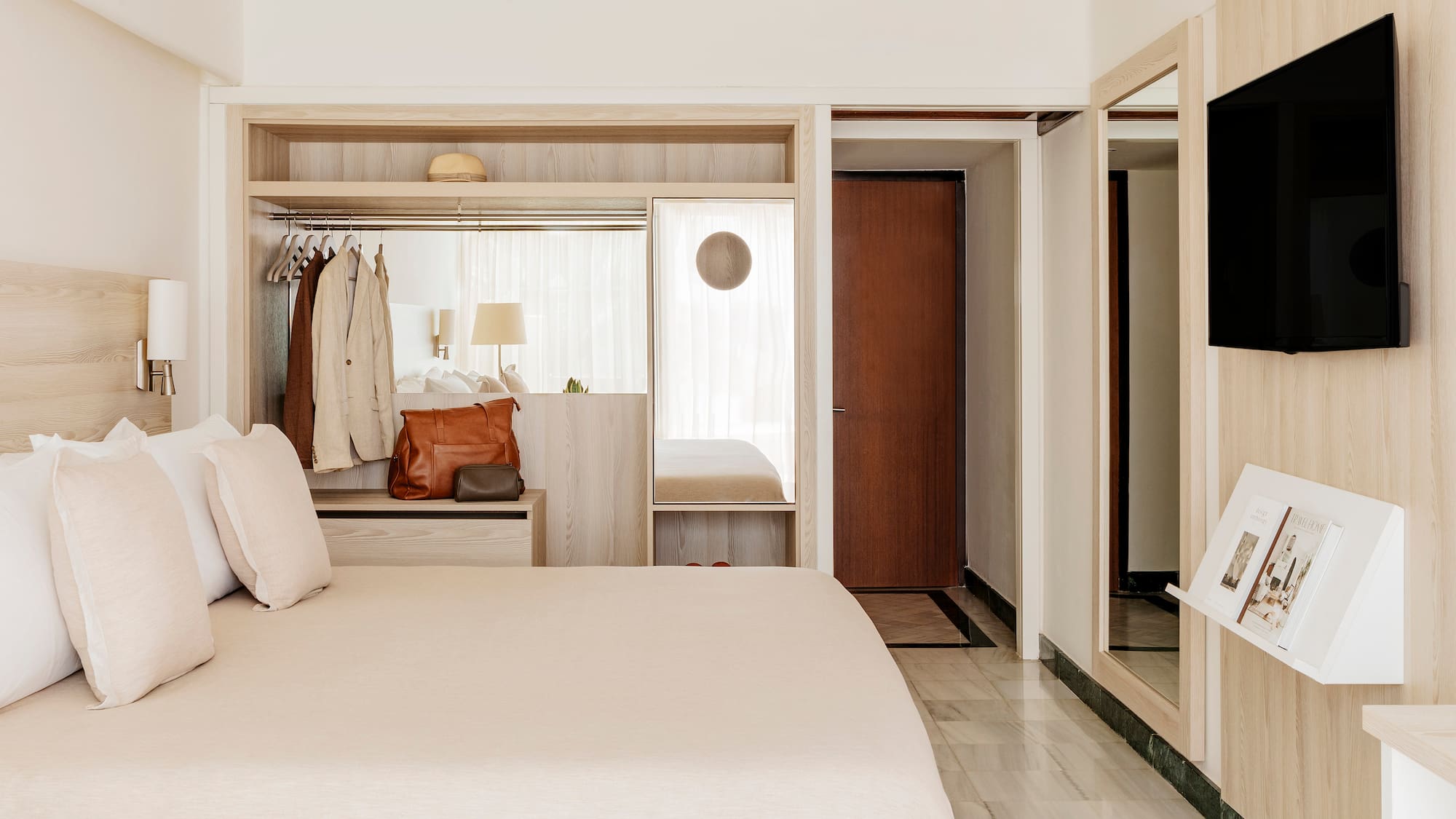 a bedroom with a bed and a mirror