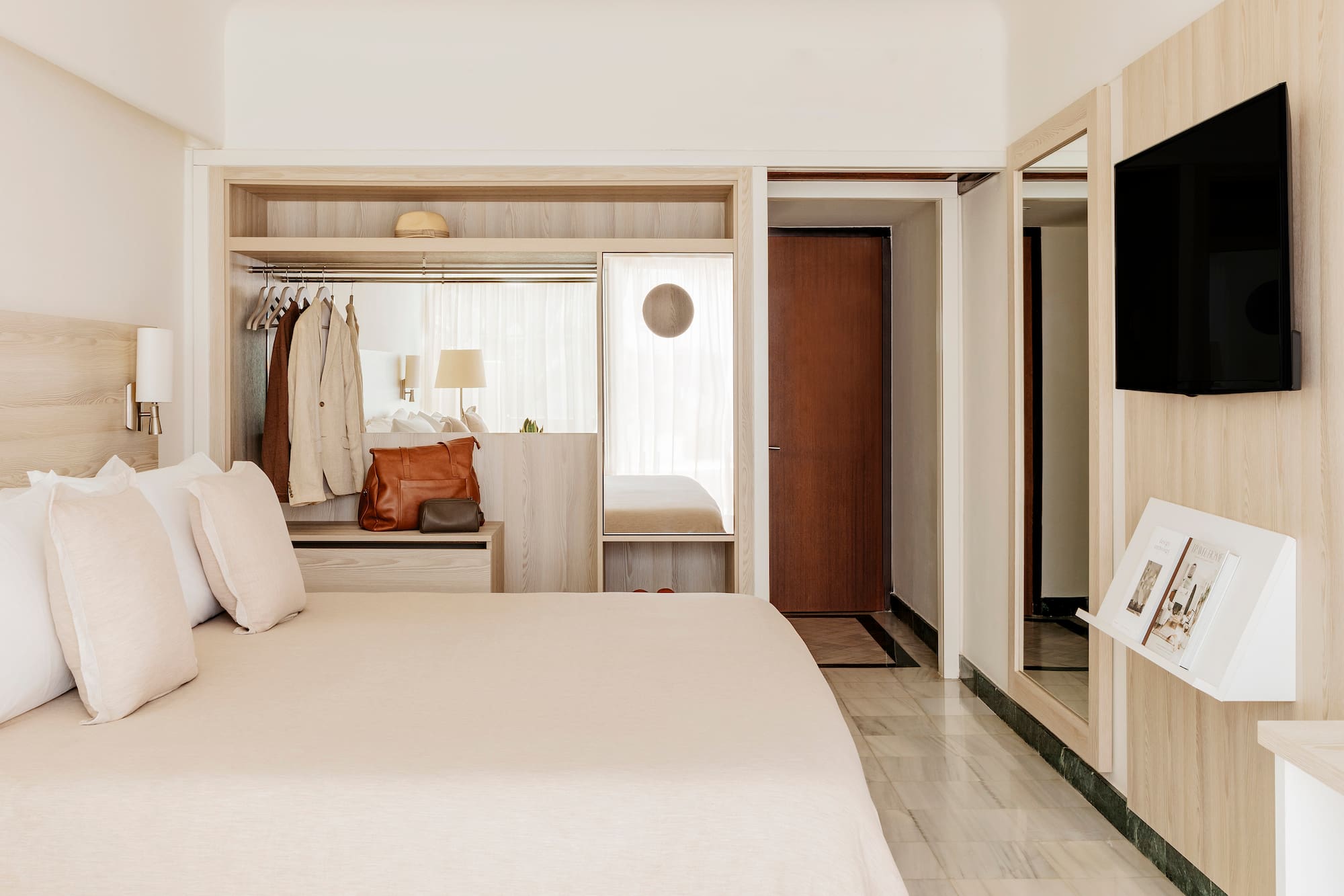 a bedroom with a bed and a mirror