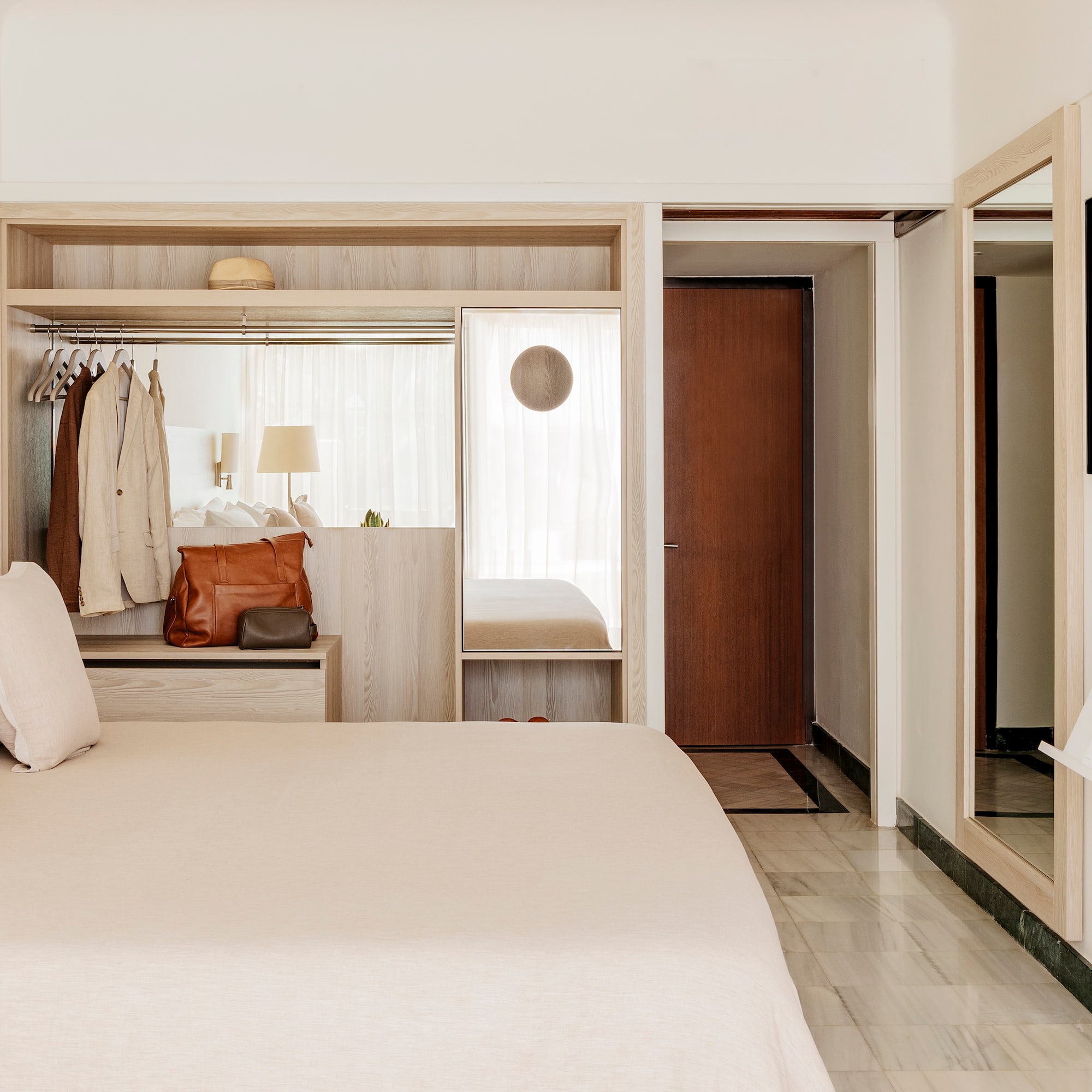 a bedroom with a bed and a mirror