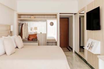 a bedroom with a bed and a mirror