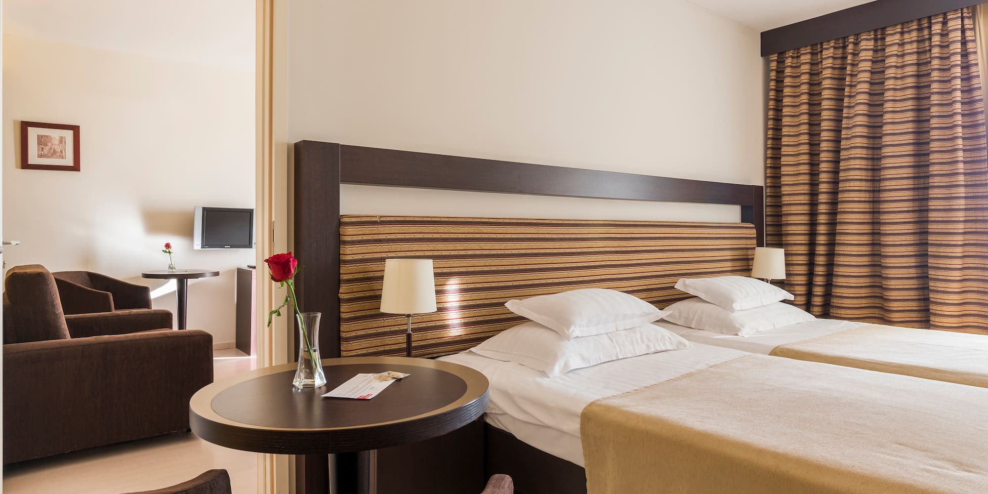 a room with two beds and a table