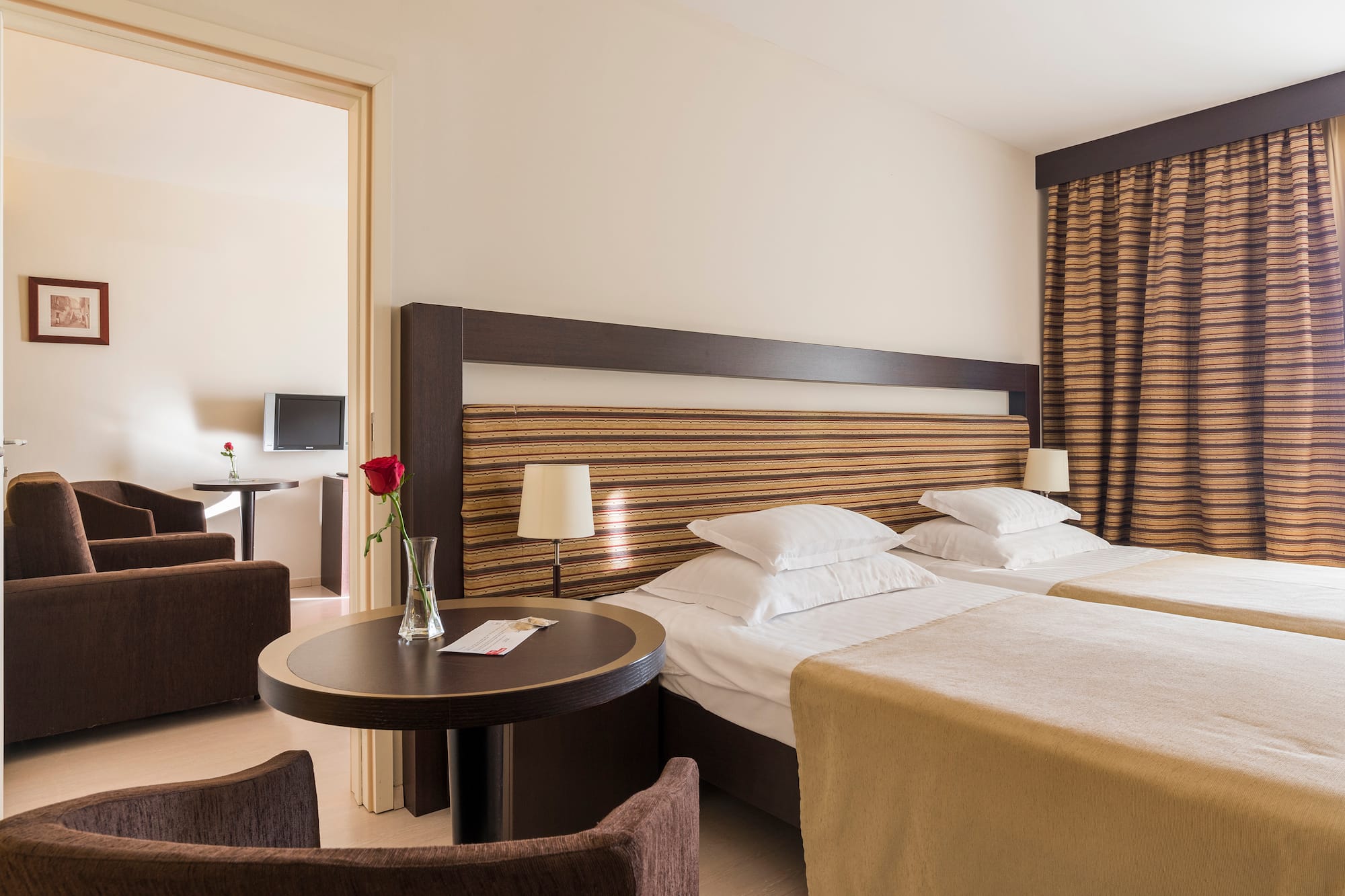 a room with two beds and a table