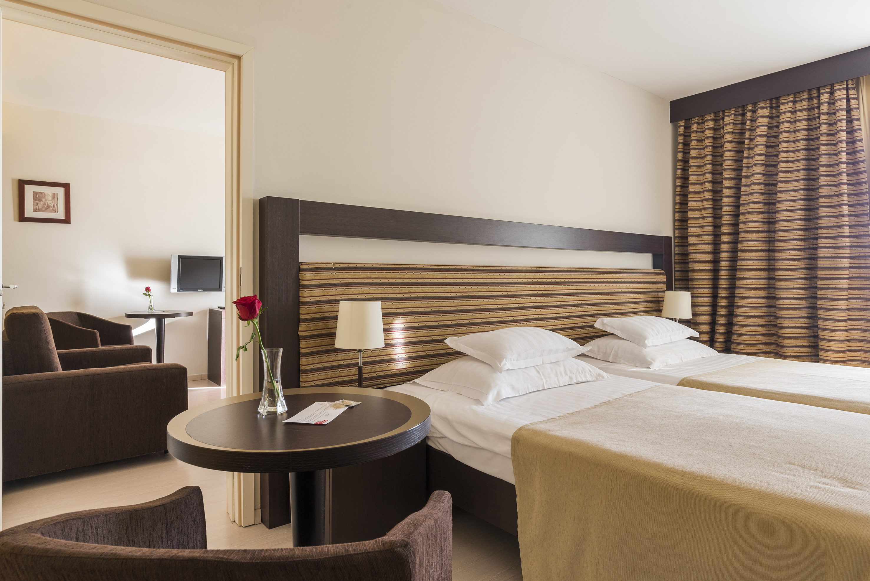 a room with two beds and a table