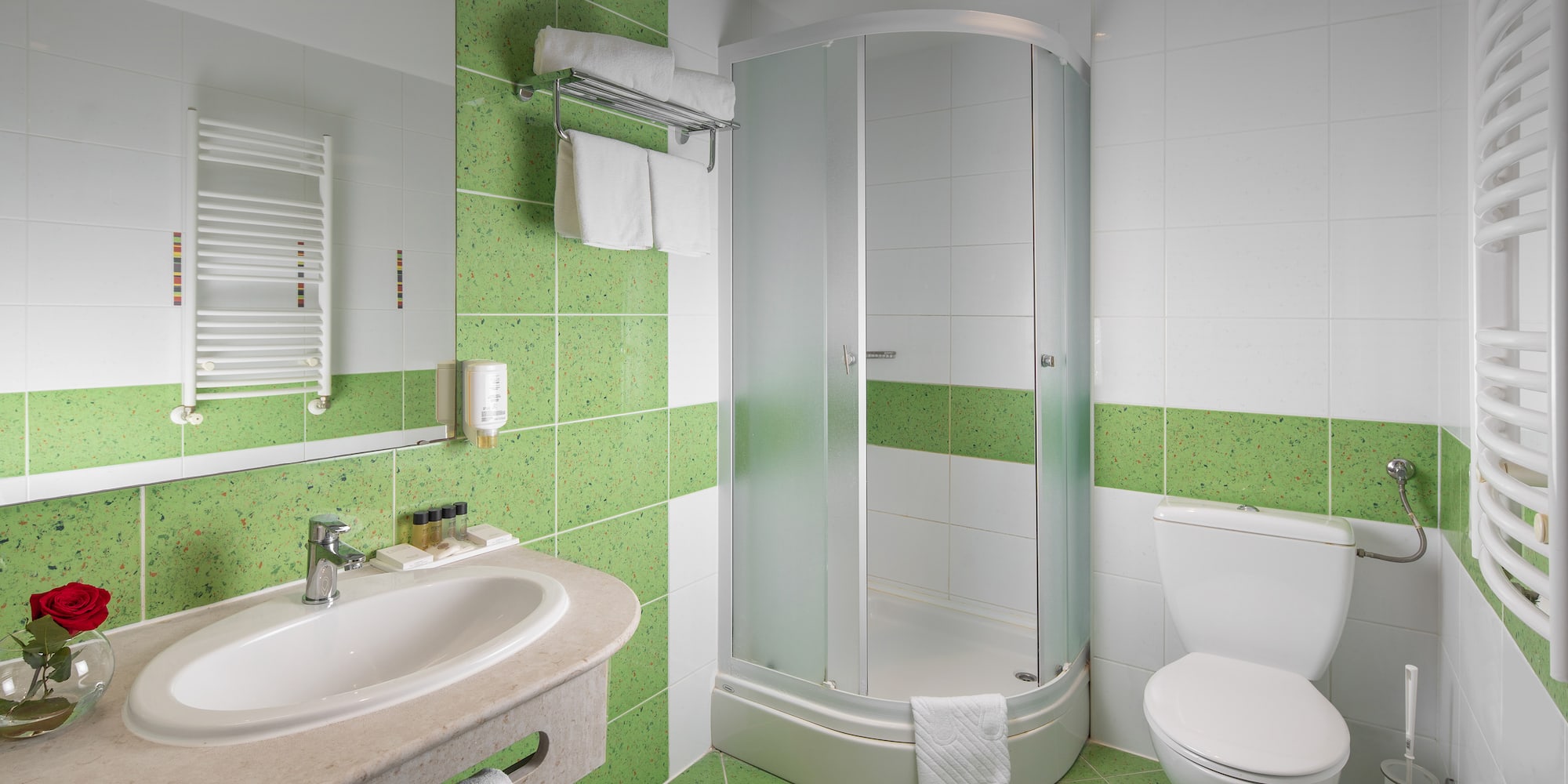 a bathroom with green tiles
