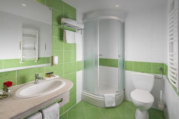 a bathroom with green tiles