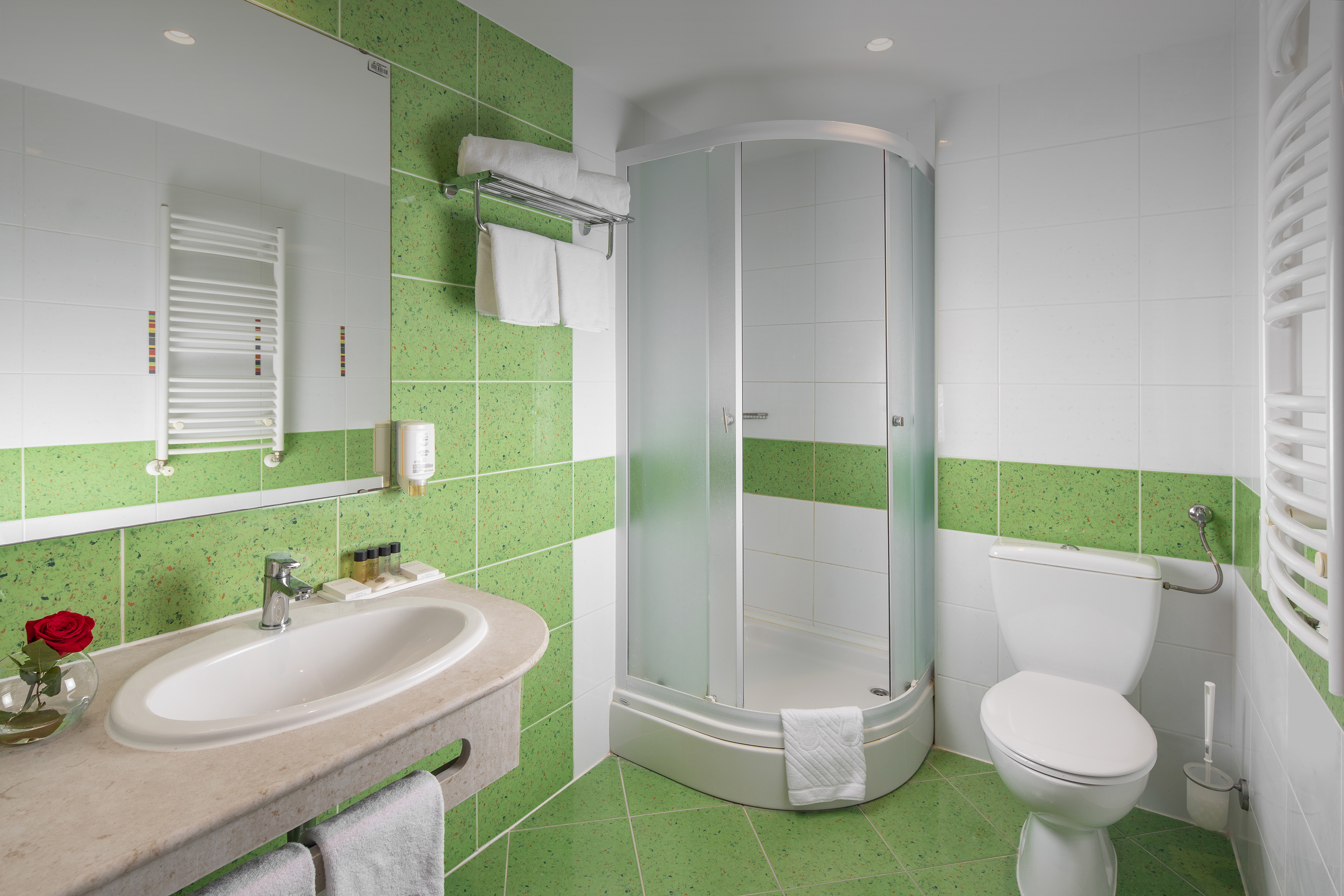 a bathroom with green tiles