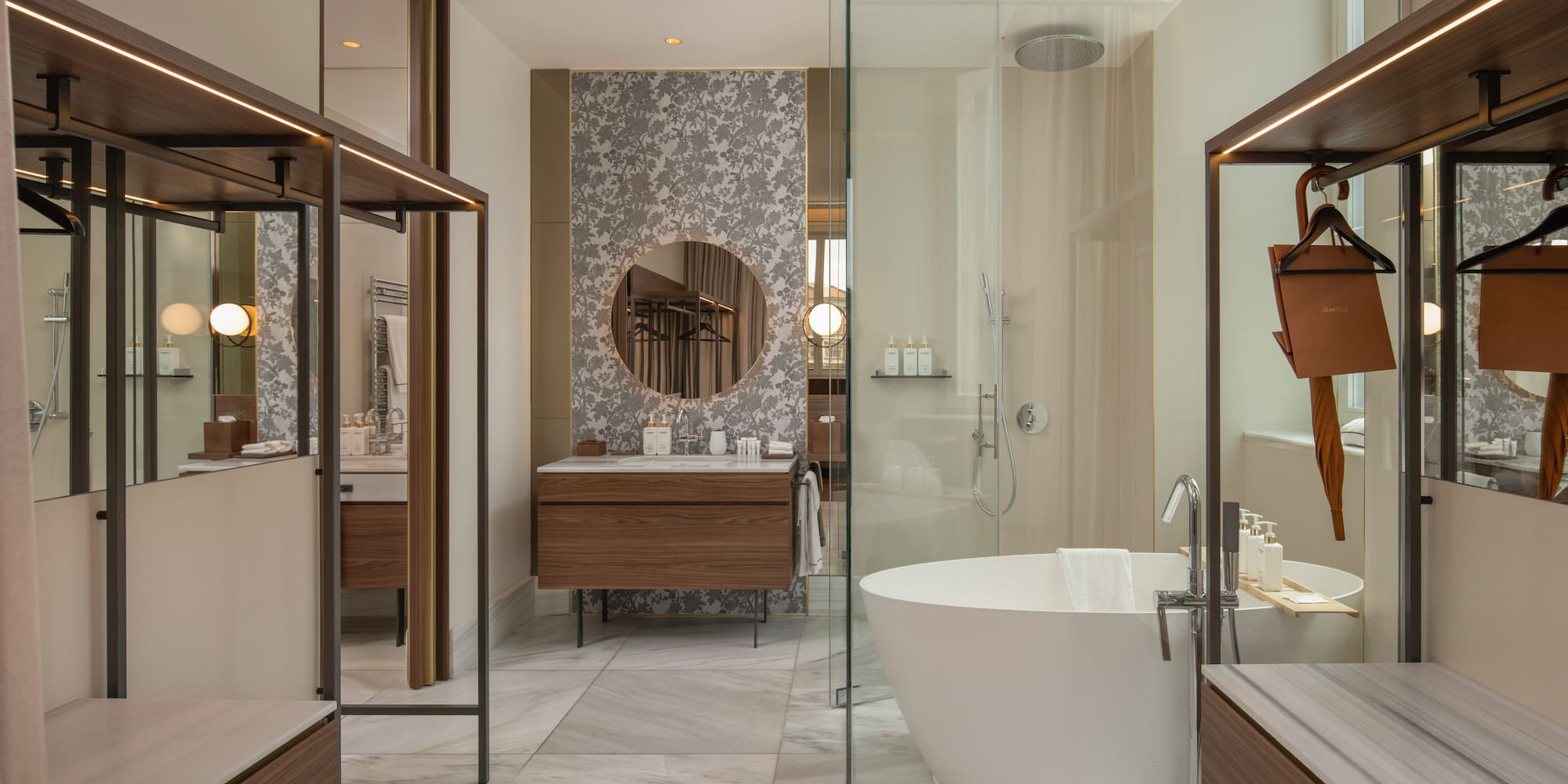 Modern luxury bathroom with freestanding tub, glass shower, and wood vanity.