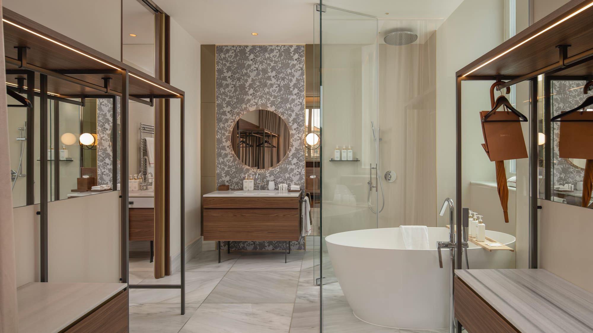 Modern luxury bathroom with freestanding tub, glass shower, and wood vanity.