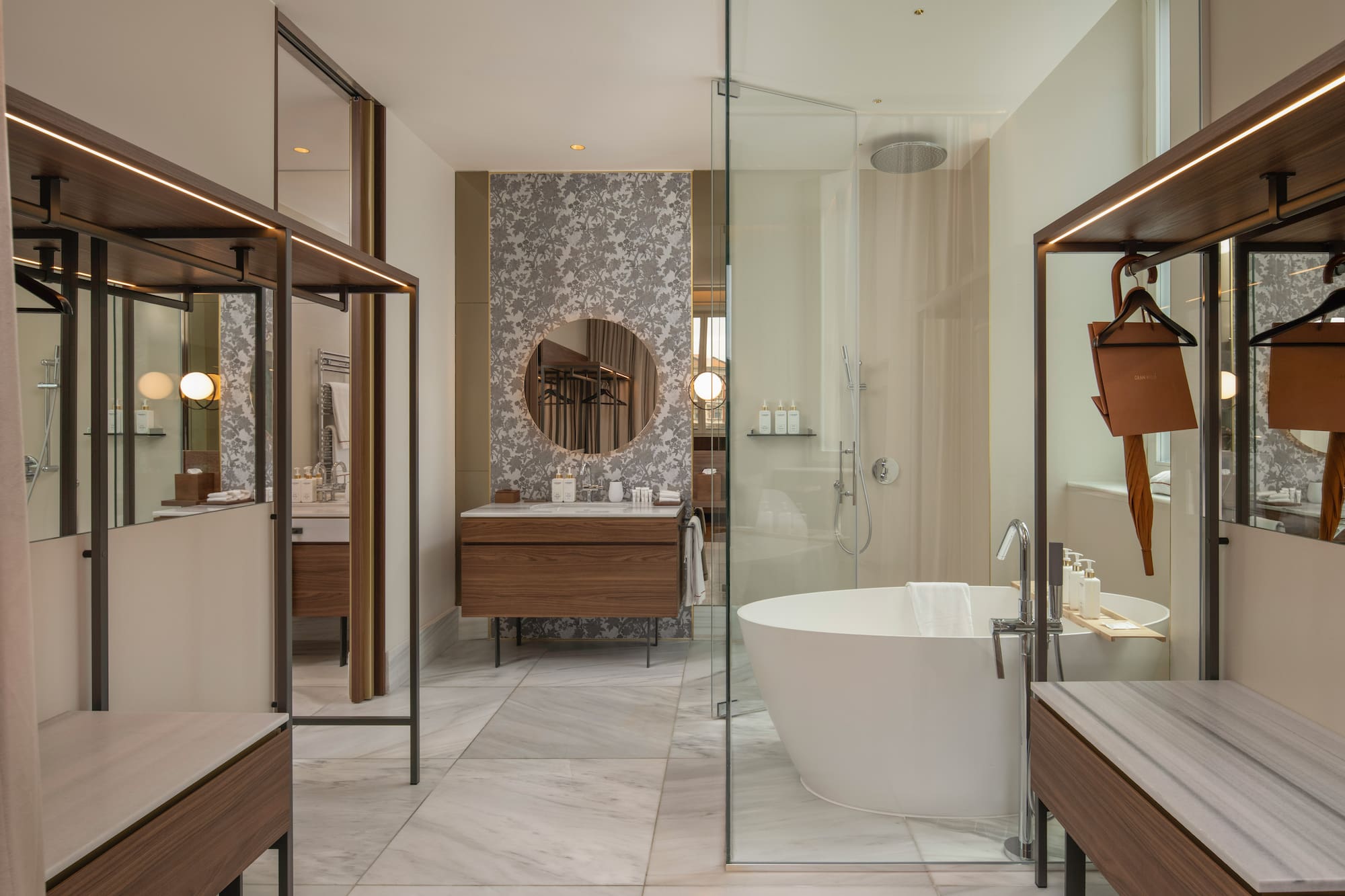 Modern luxury bathroom with freestanding tub, glass shower, and wood vanity.