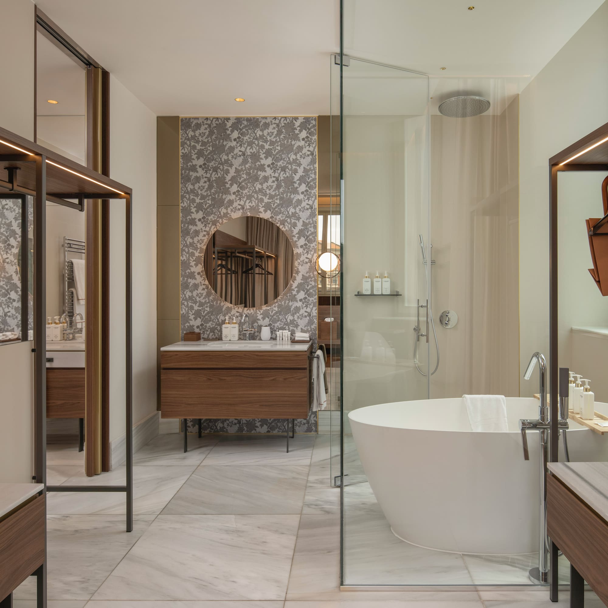 Modern luxury bathroom with freestanding tub, glass shower, and wood vanity.