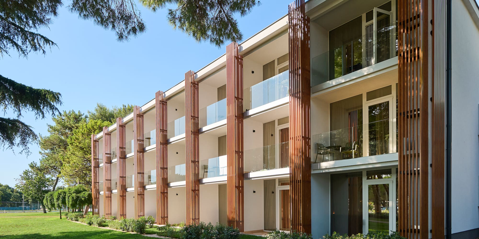 a building with a lawn and trees
