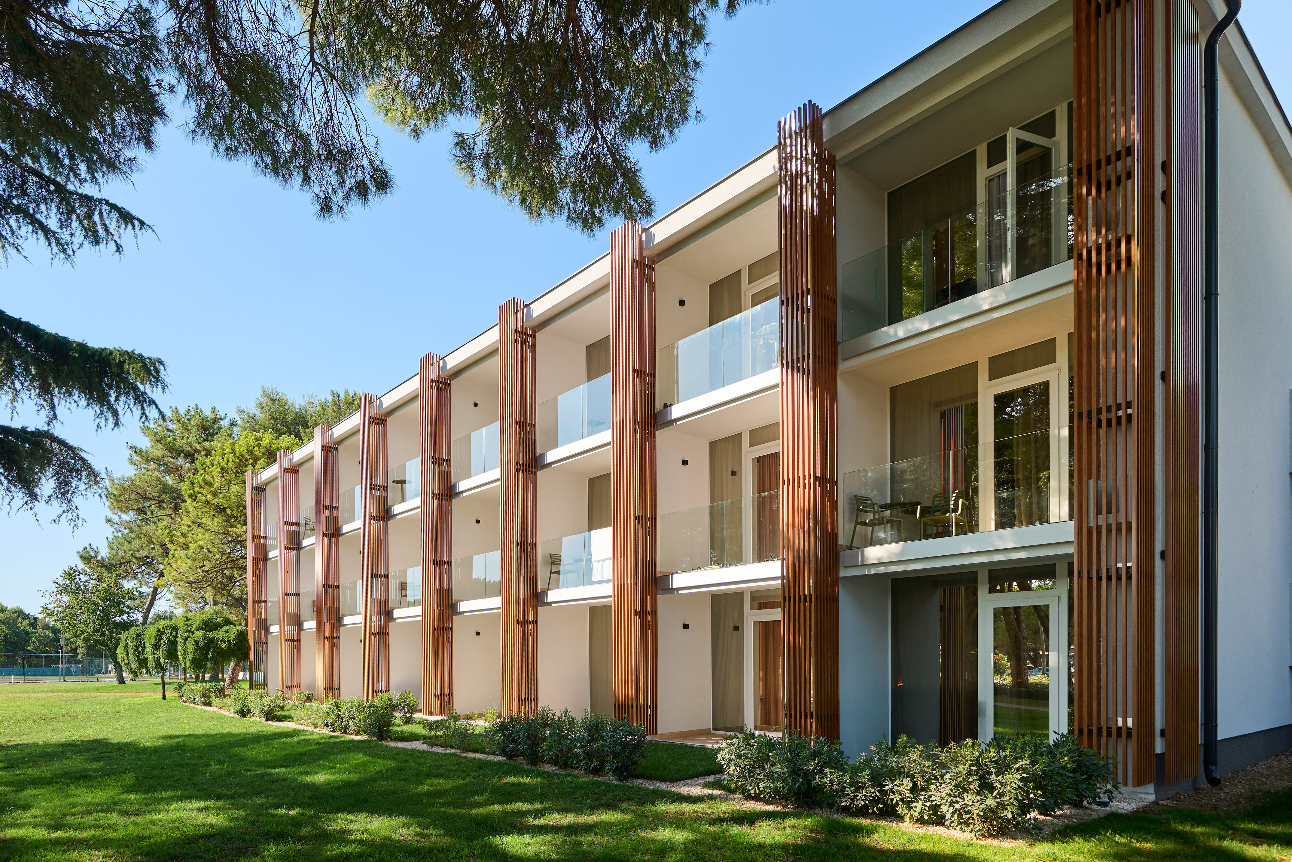 a building with a lawn and trees