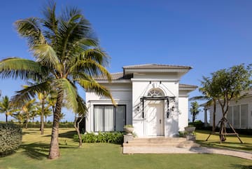 a white house with palm trees