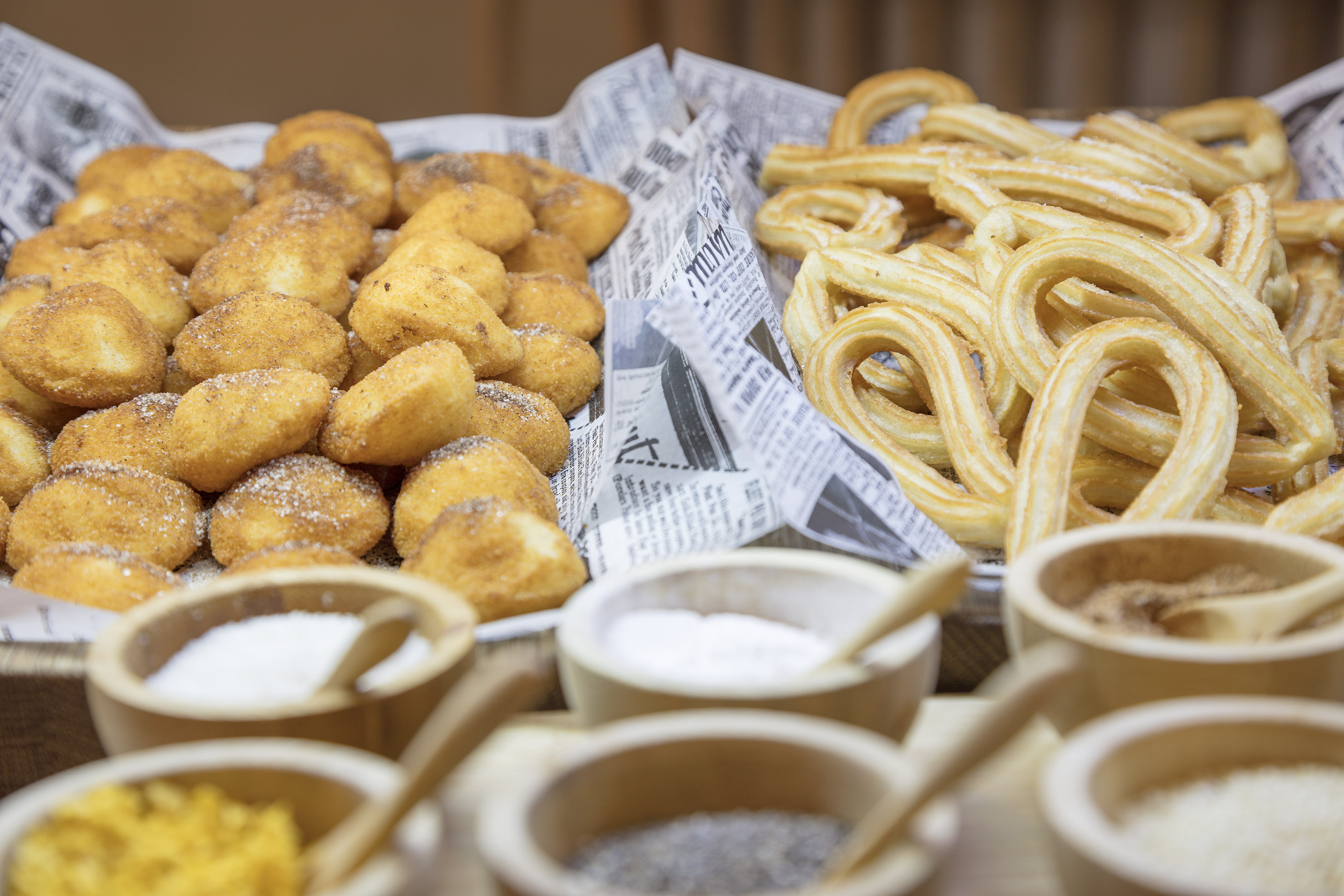 Golden churros and cinnamon sugar pastries with various toppings.