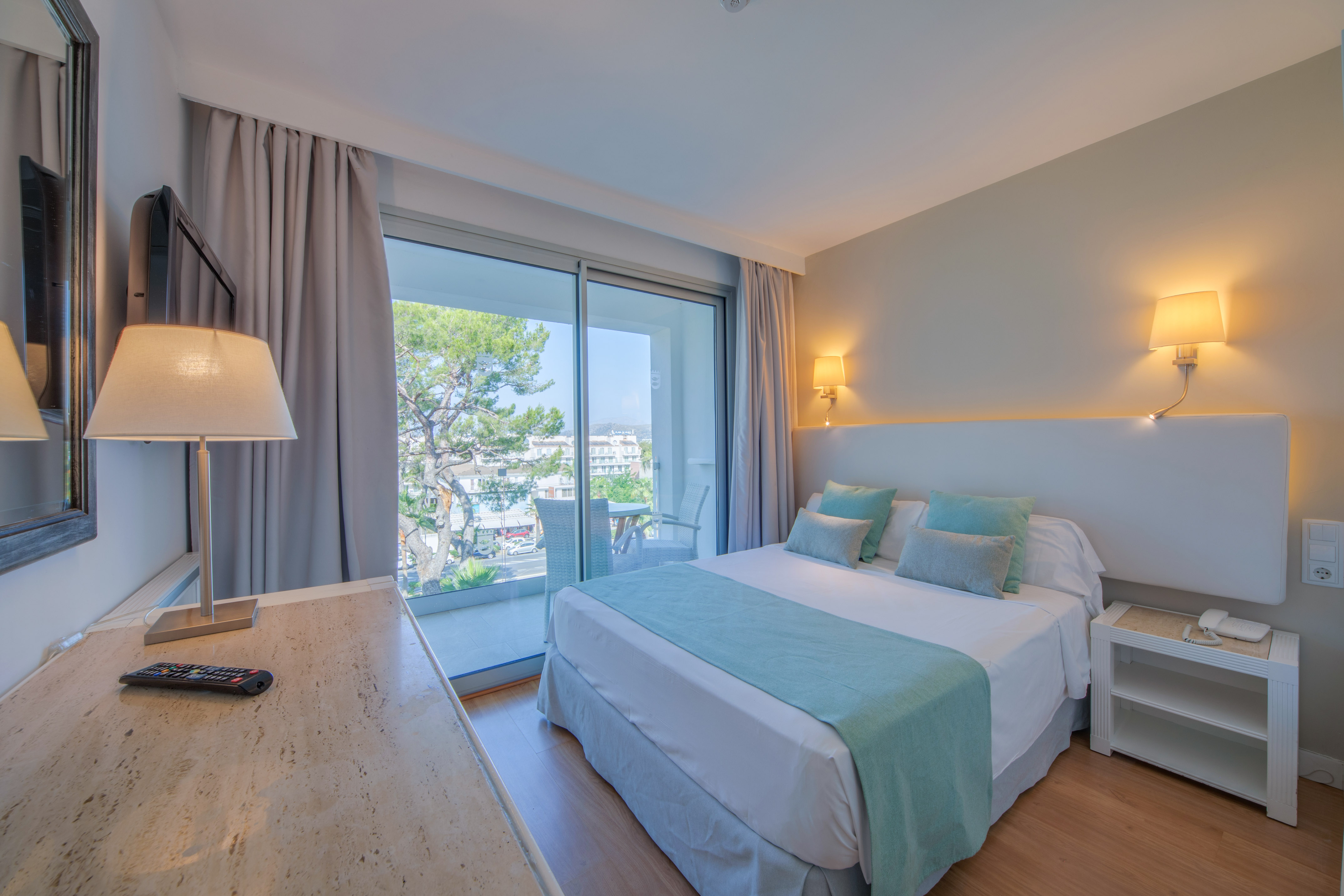 a bedroom with a desk and a bed