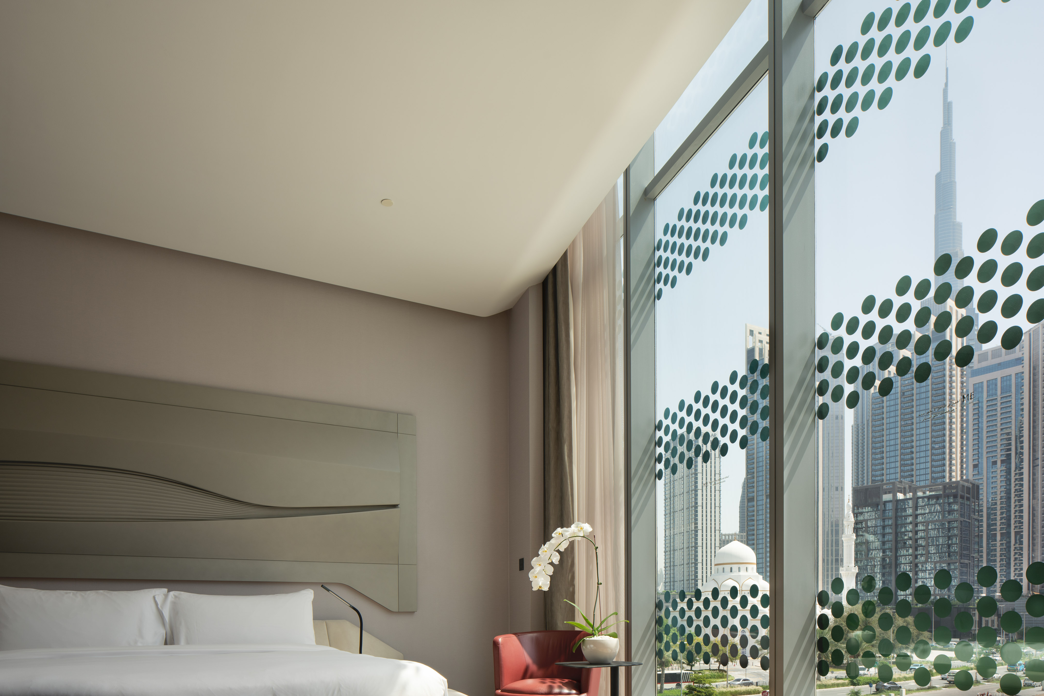Dubai hotel room, Burj Khalifa city view through patterned window.