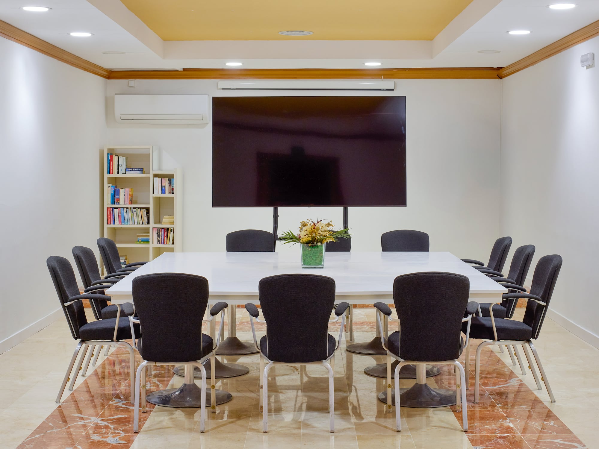 a room with a large screen and chairs