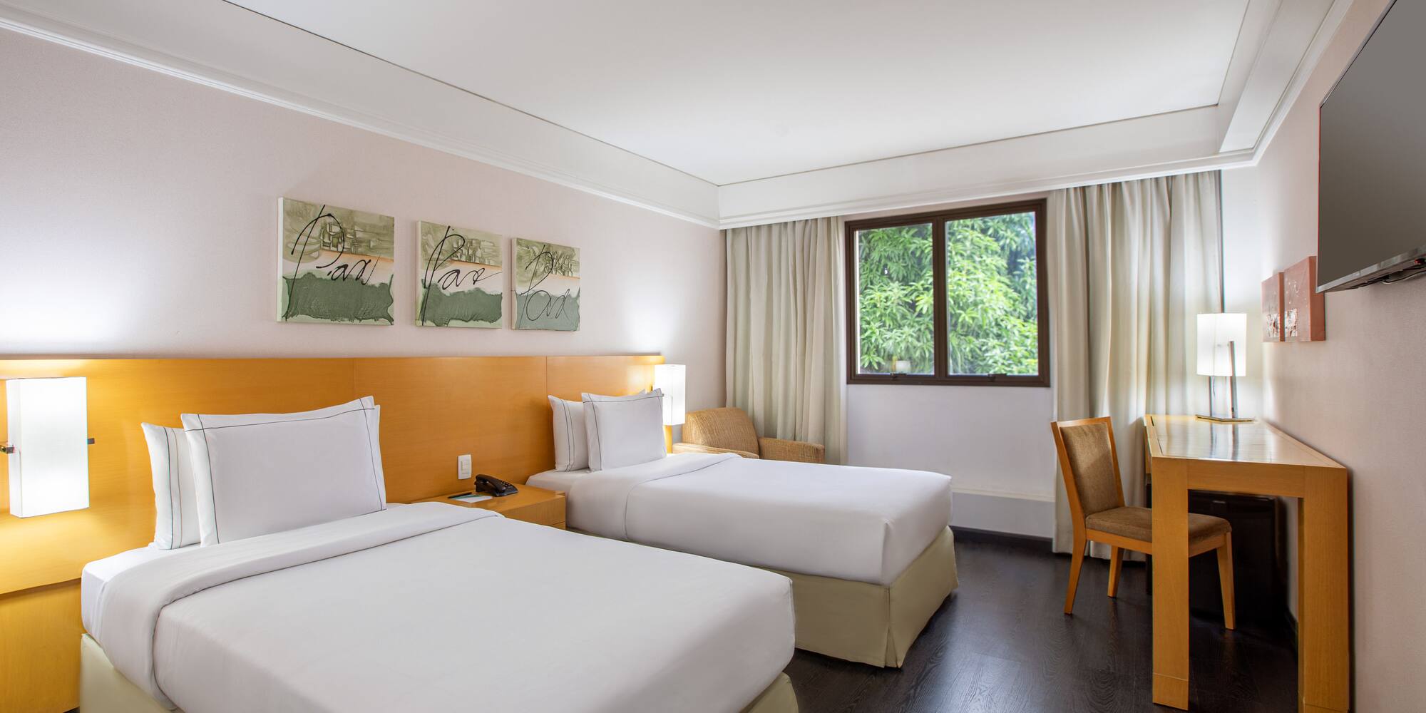 a room with two beds and a table