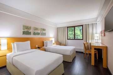 a room with two beds and a table