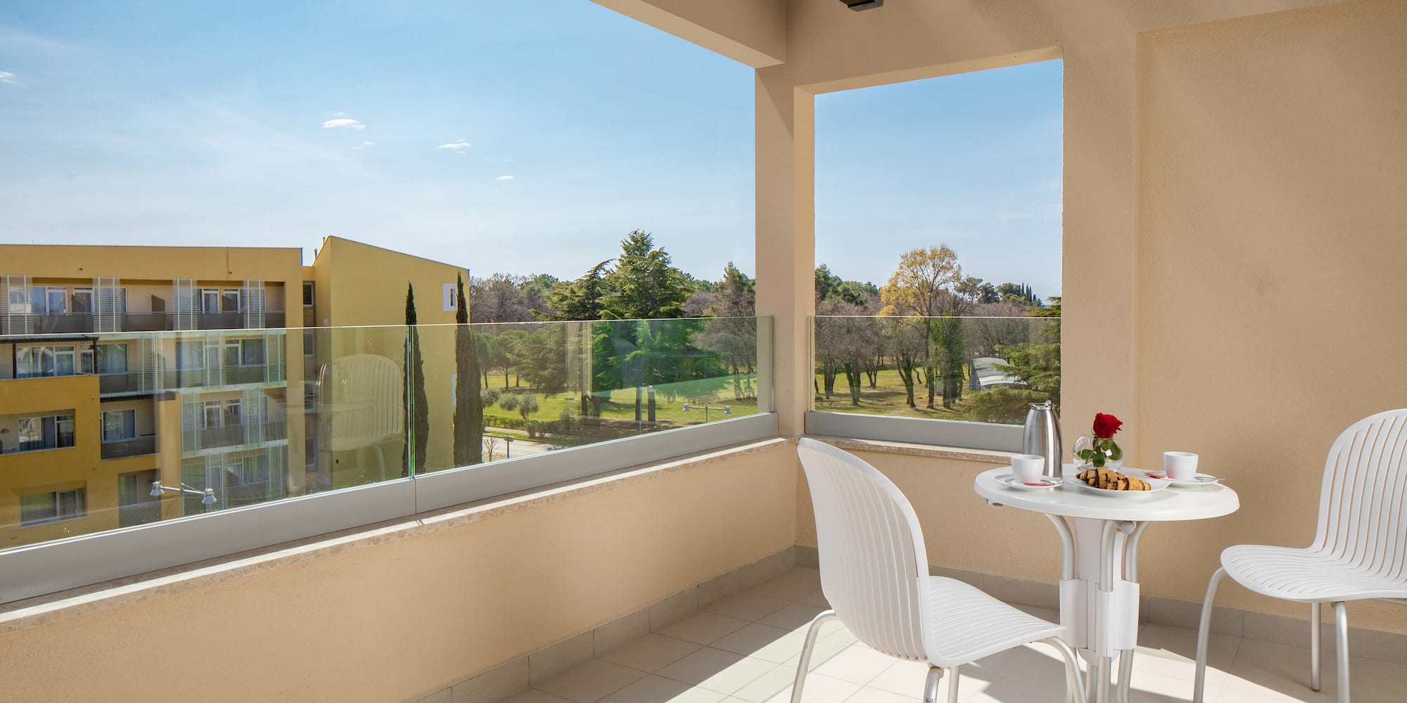 a table and chair on a balcony