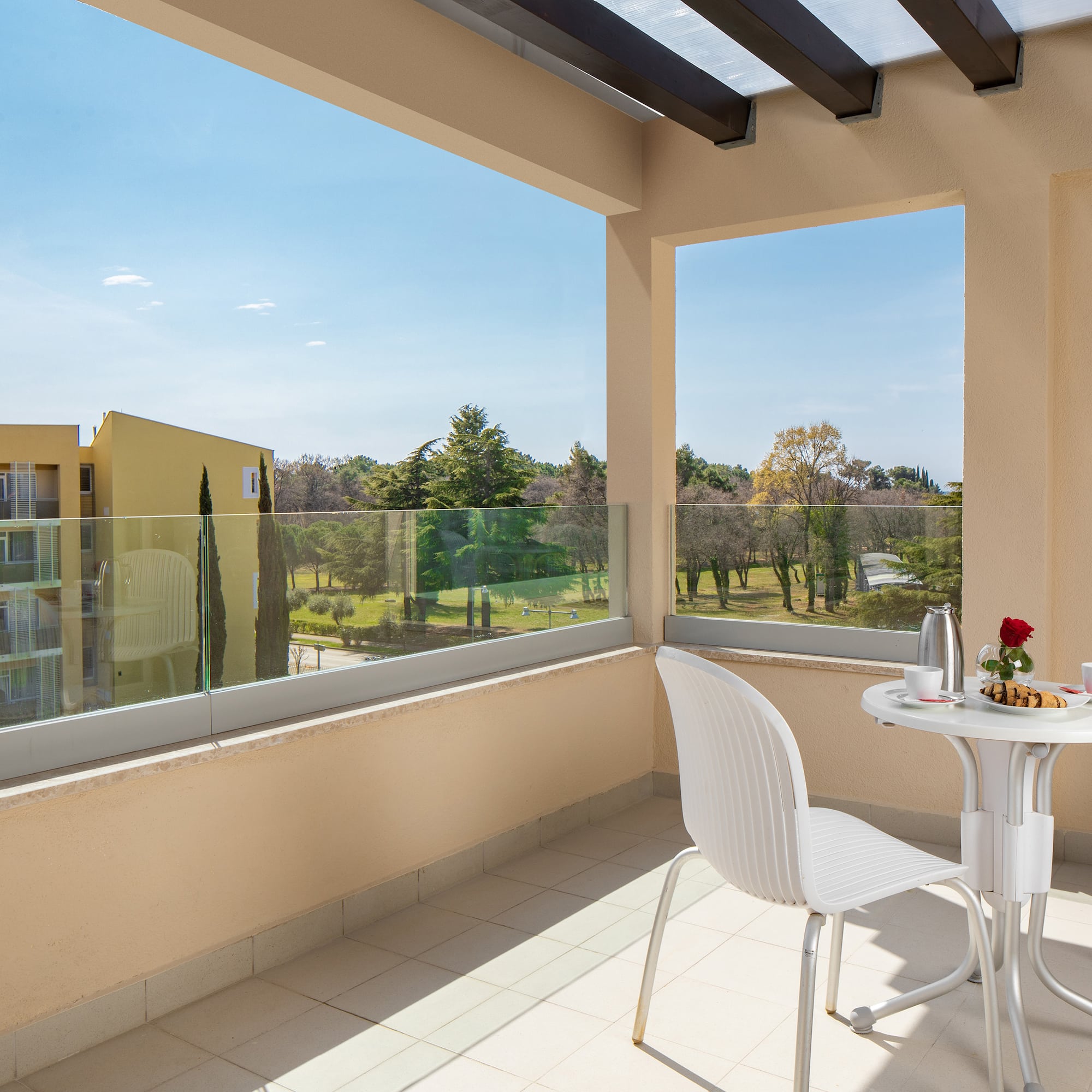 a table and chair on a balcony