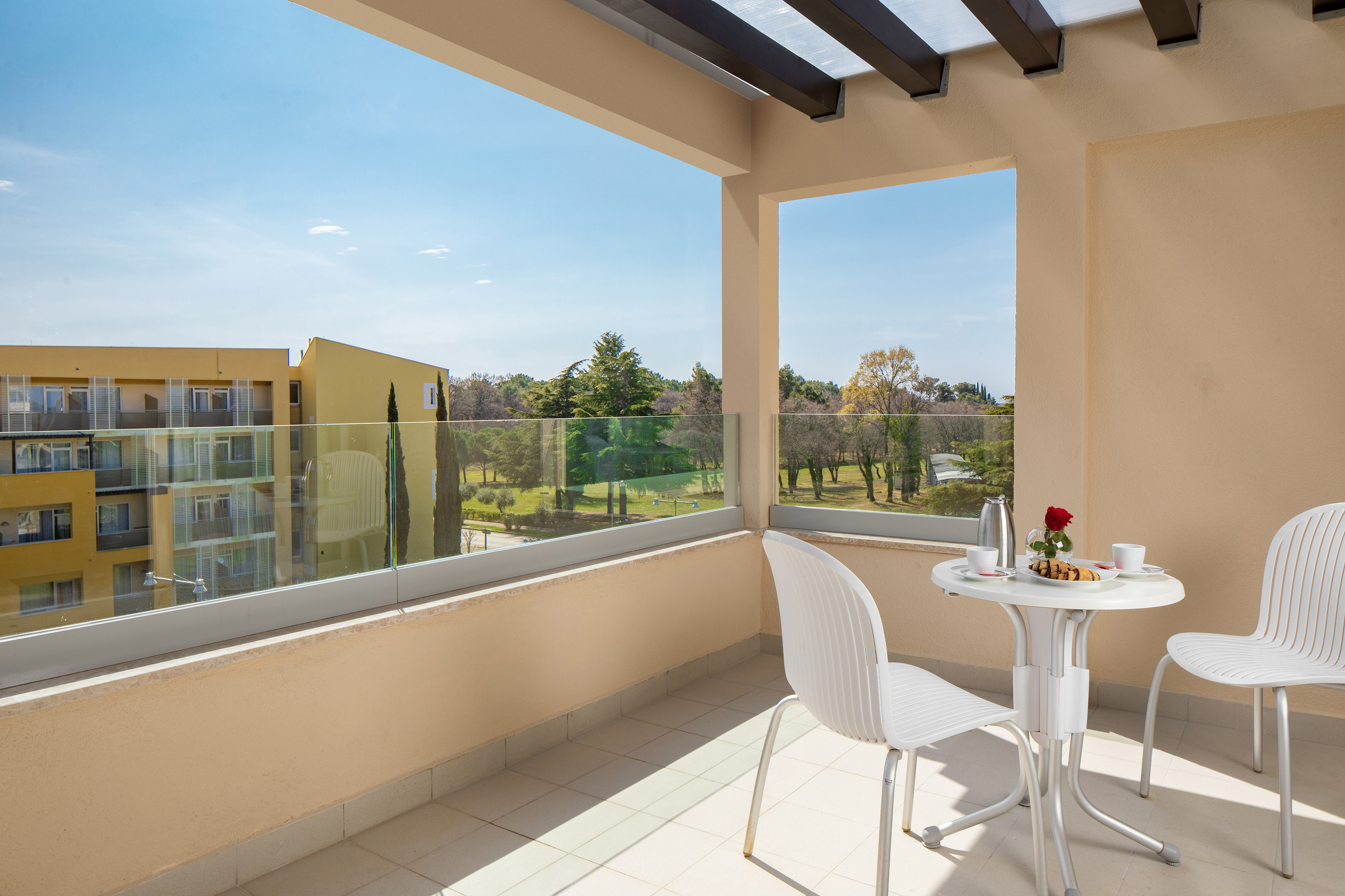 a table and chair on a balcony