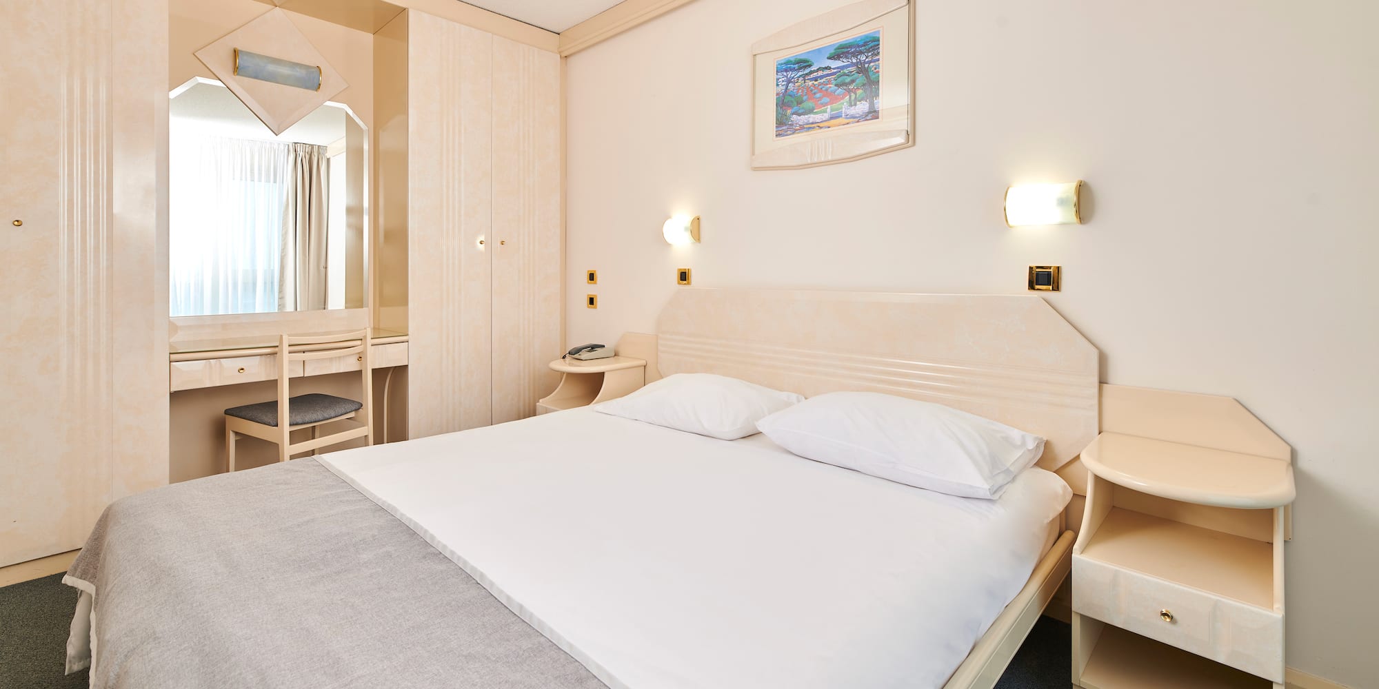 a bed with a mirror and a table