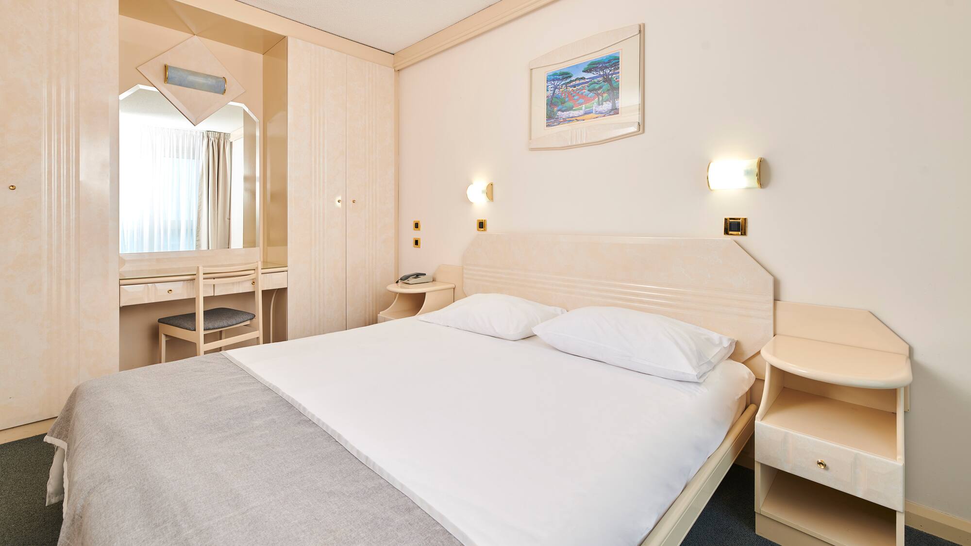 a bed with a mirror and a table