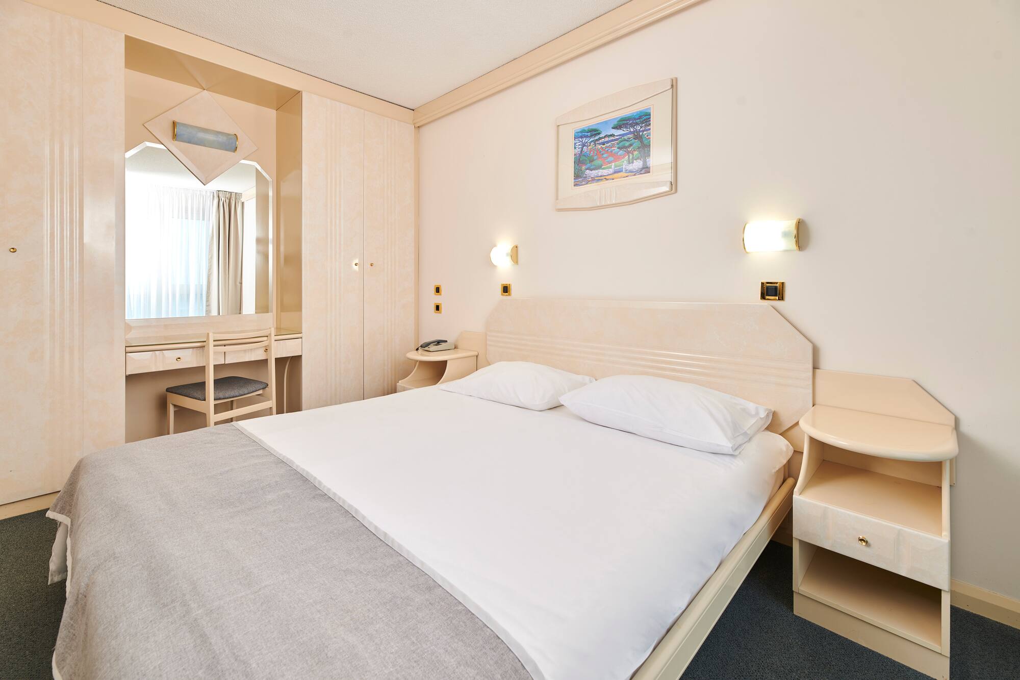 a bed with a mirror and a table