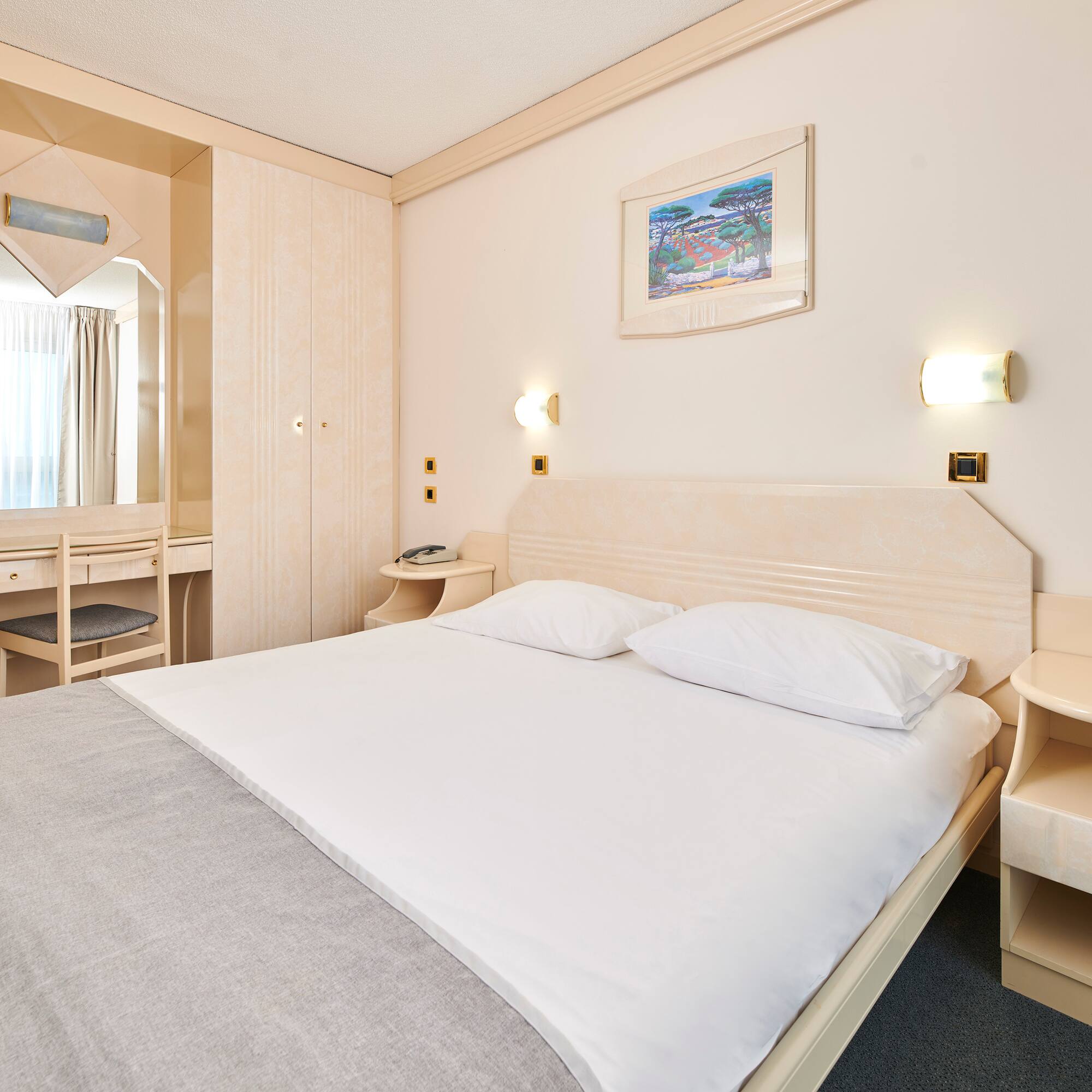 a bed with a mirror and a table