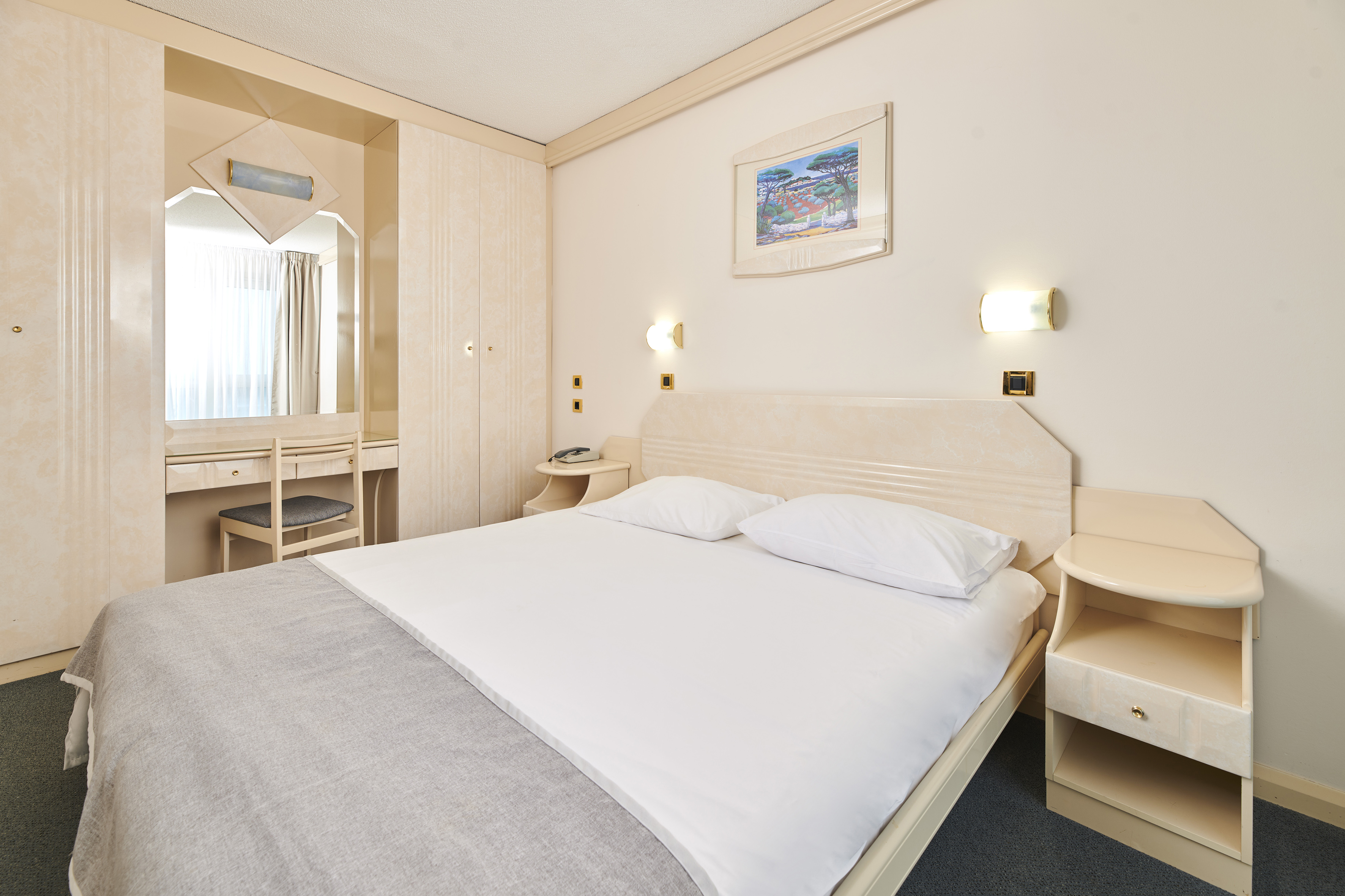 a bed with a mirror and a table