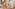 Woman plays with wooden train set, teepee, panda, orangutan toys in kids' room.