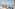 Beachfront resort patio with modern lounge furniture and ocean view.