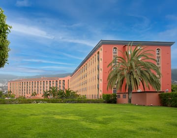 a large building with palm trees in front of it