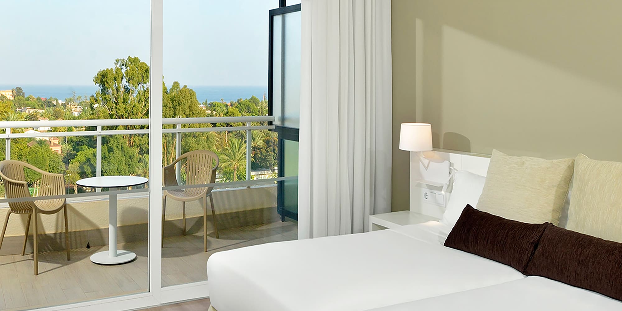 a bedroom with a glass door and a balcony